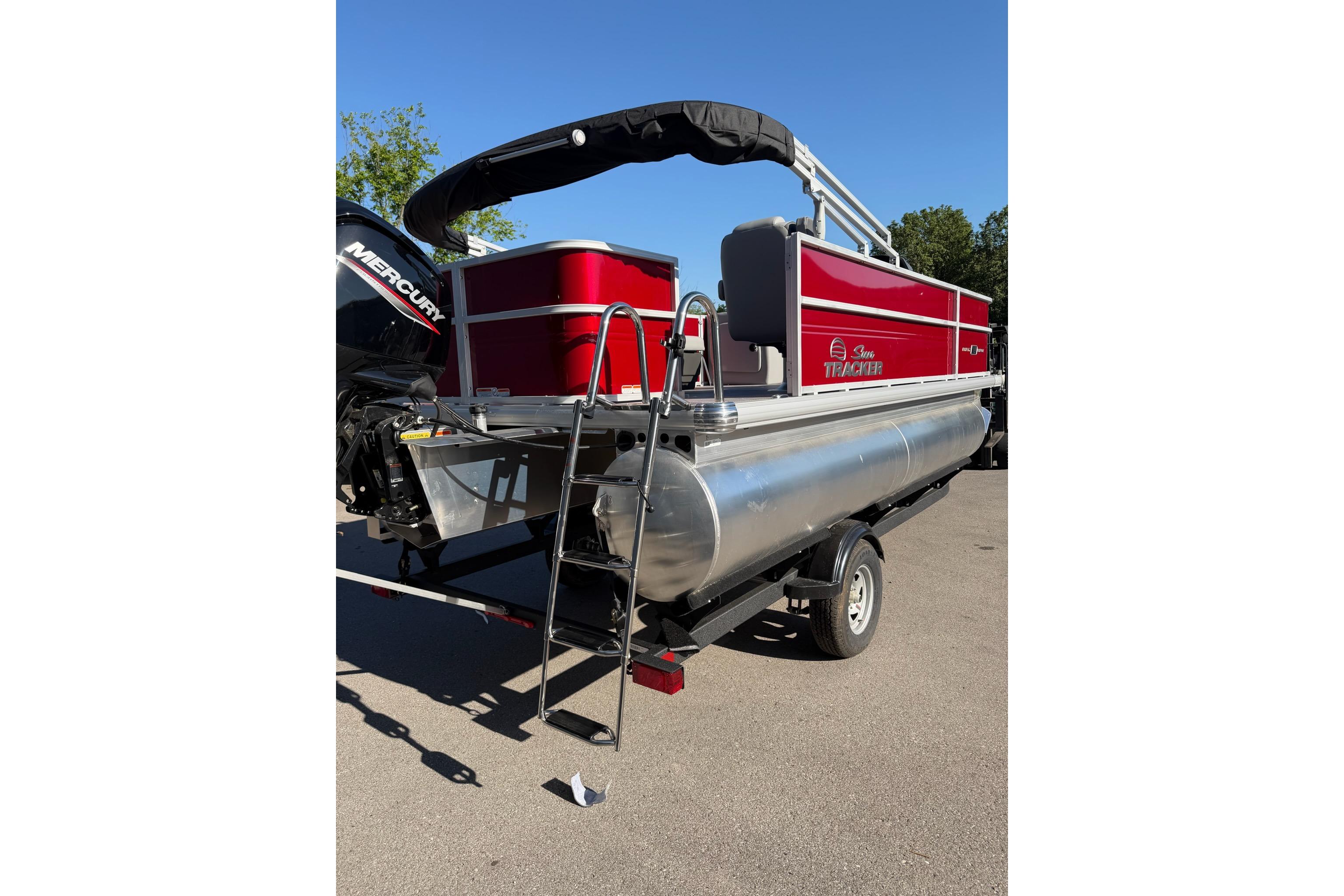 2026 Sun Tracker Party Barge 18 DLX pontoon boat with Mercury engine, red exterior.