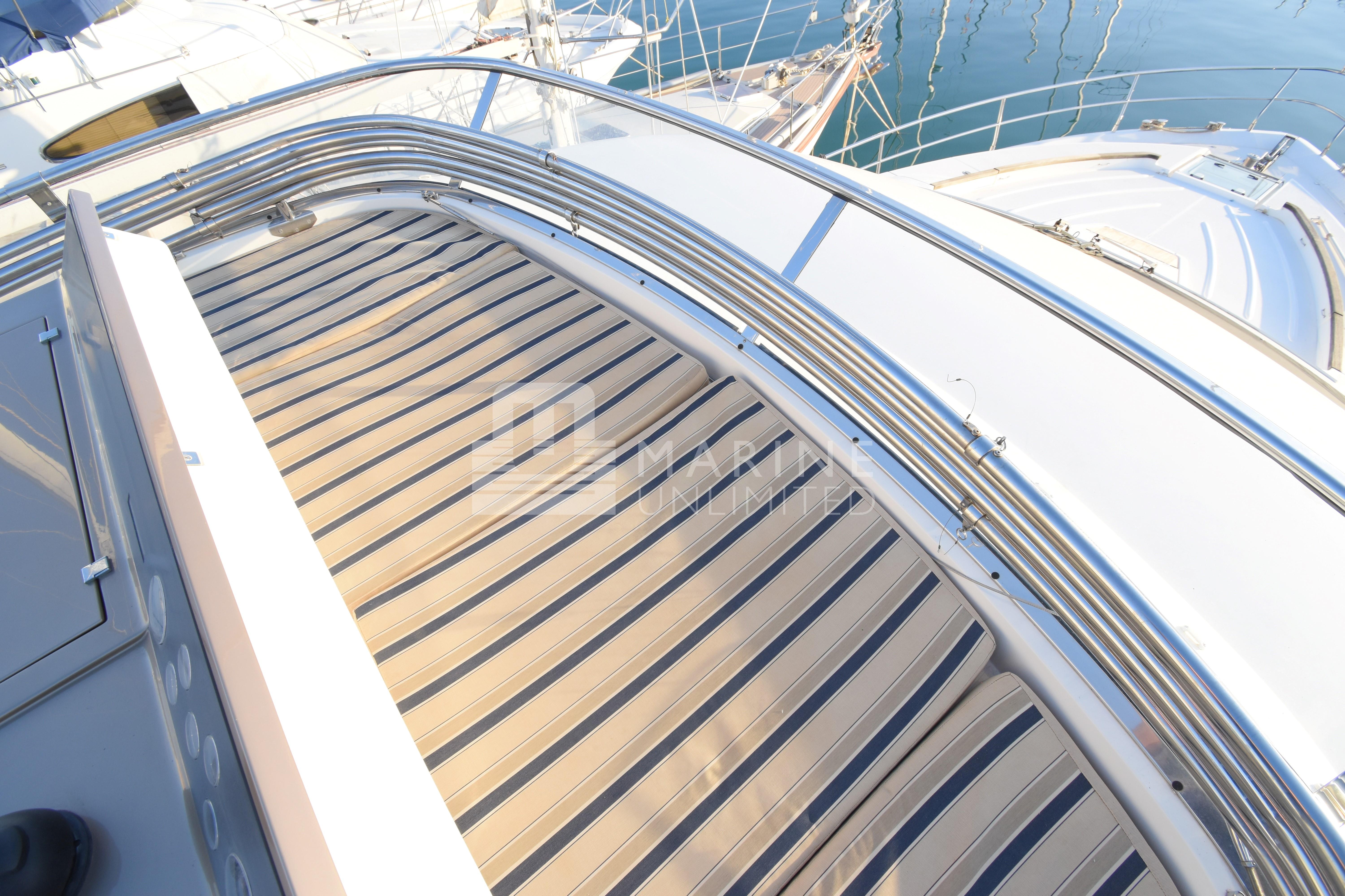 2010 Fairline Squadron 55 yacht deck with striped sunbed and railing.