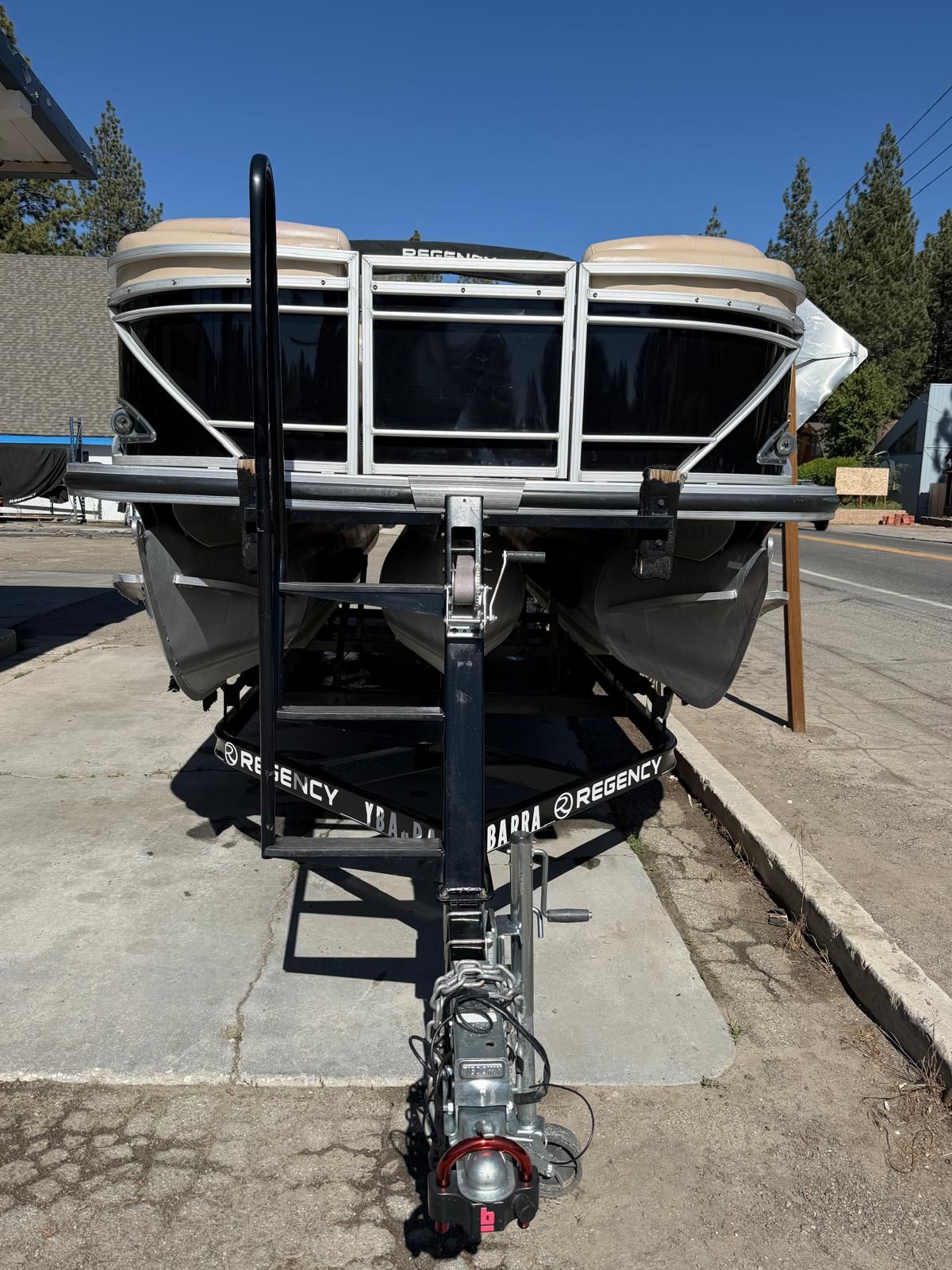 2015 Regency 220DL3 pontoon boat on trailer, front view.