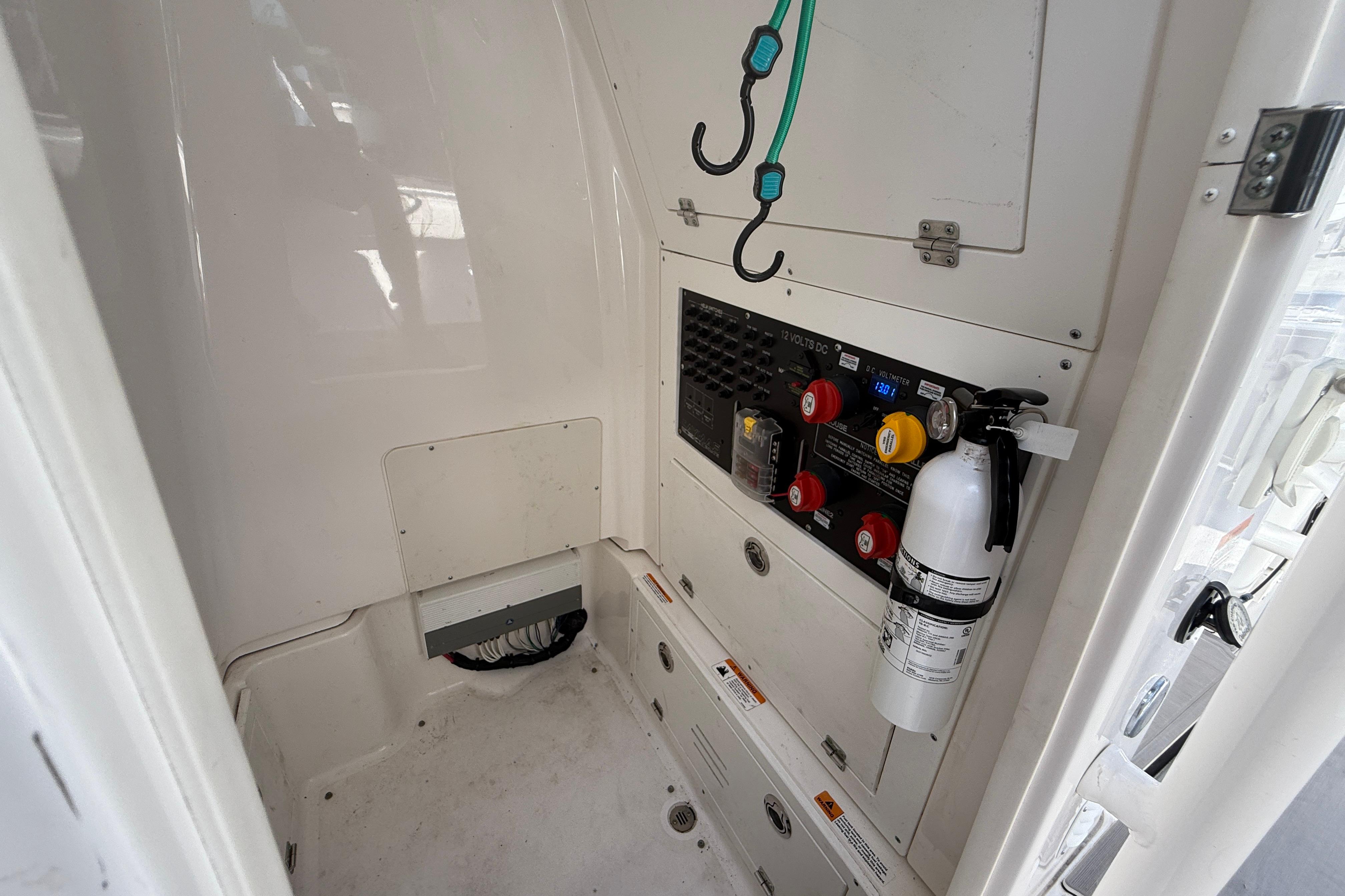 Interior of 2022 Caymas 28 HB Twin boat with control panel and fire extinguisher.