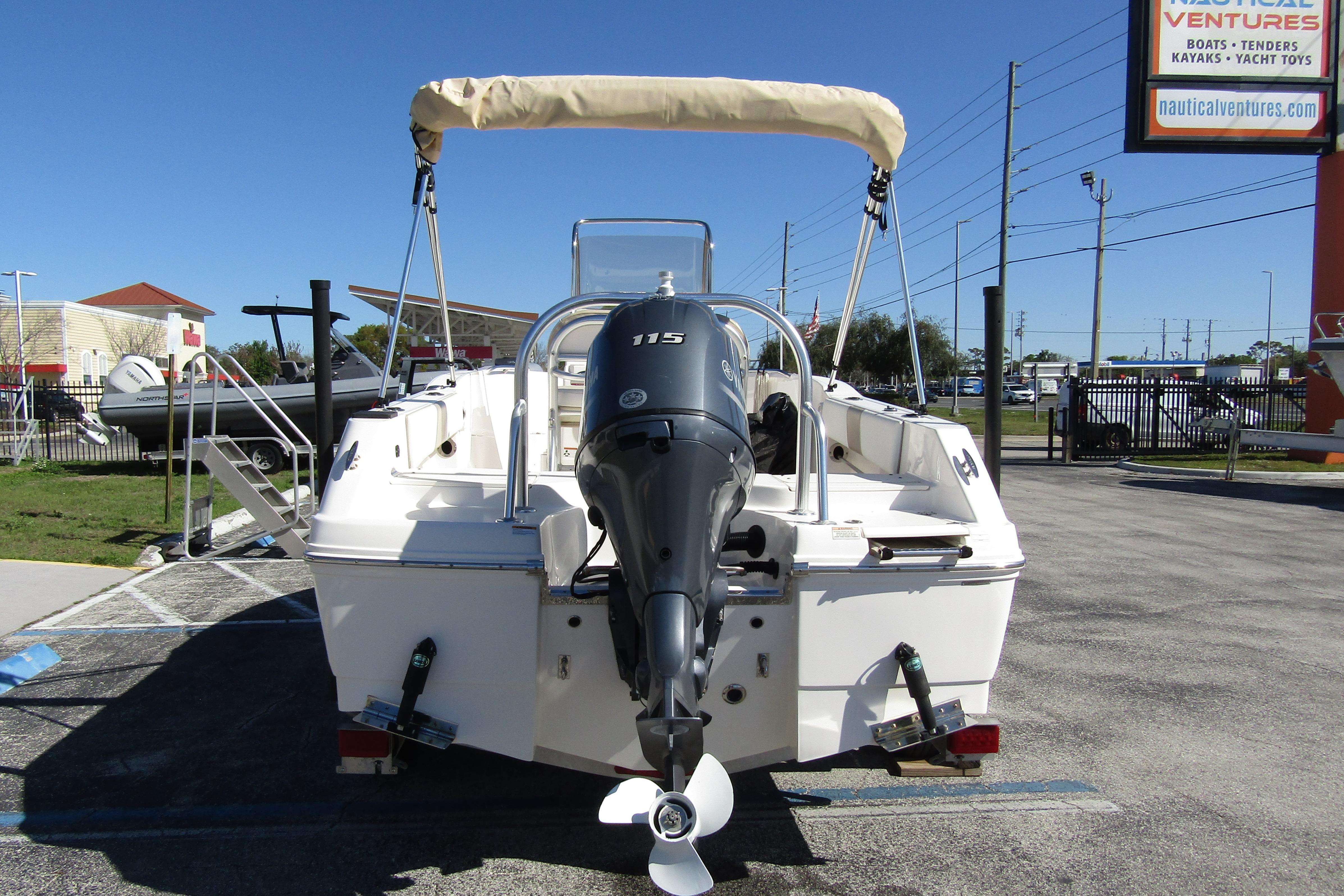 2019 Robalo R180 Center Console boat with outboard motor, parked outdoors.