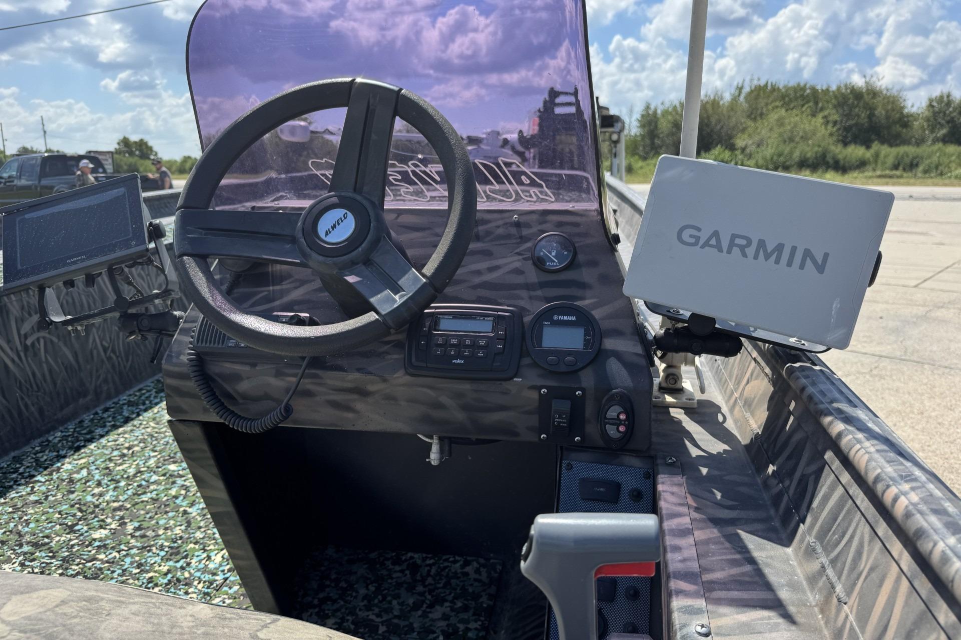 2022 Alweld 2270 boat dashboard with Garmin navigation system and steering wheel.