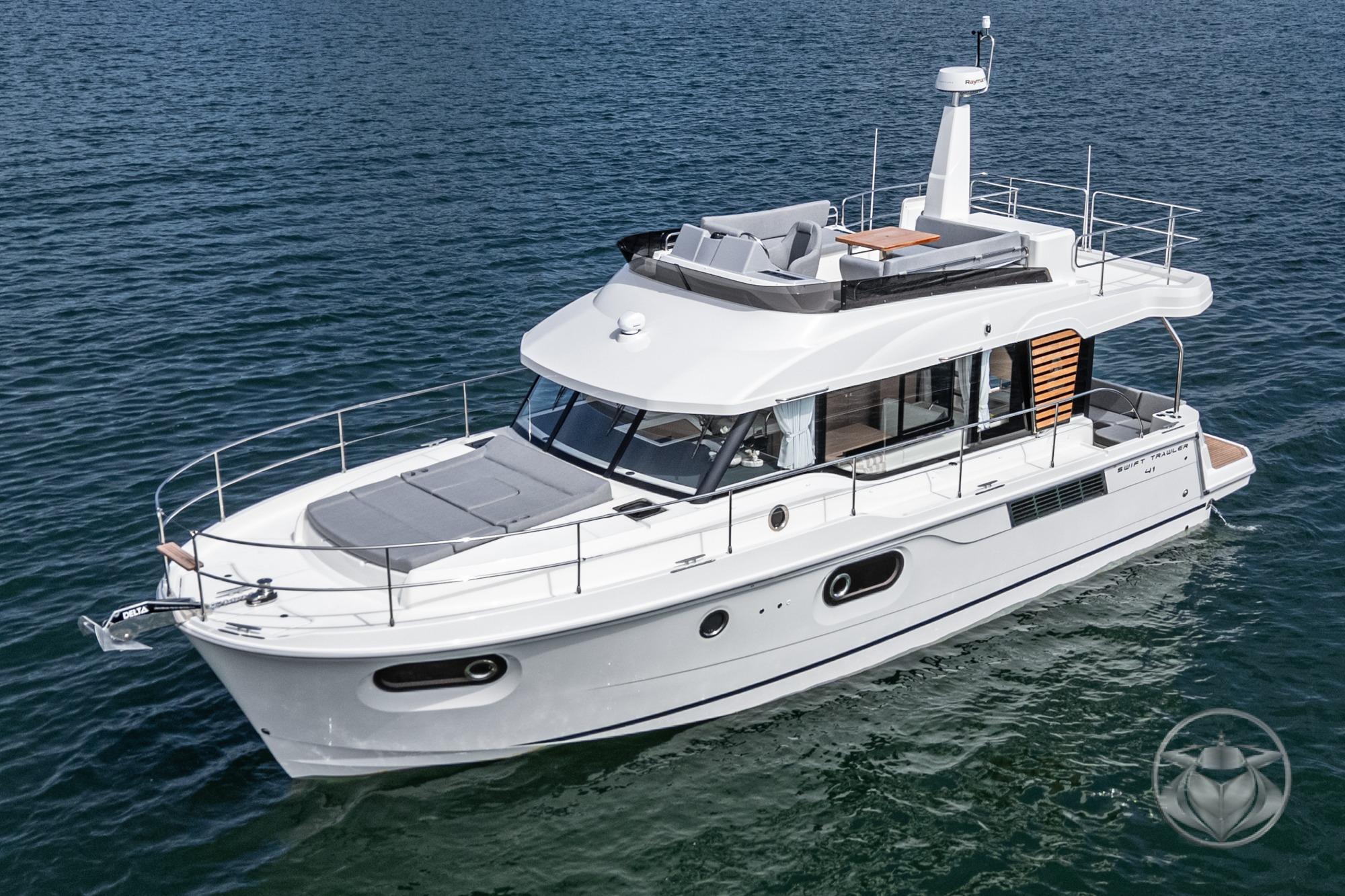 2026 Beneteau Swift Trawler 41 Fly cruising on open water, showcasing sleek design and spacious deck.