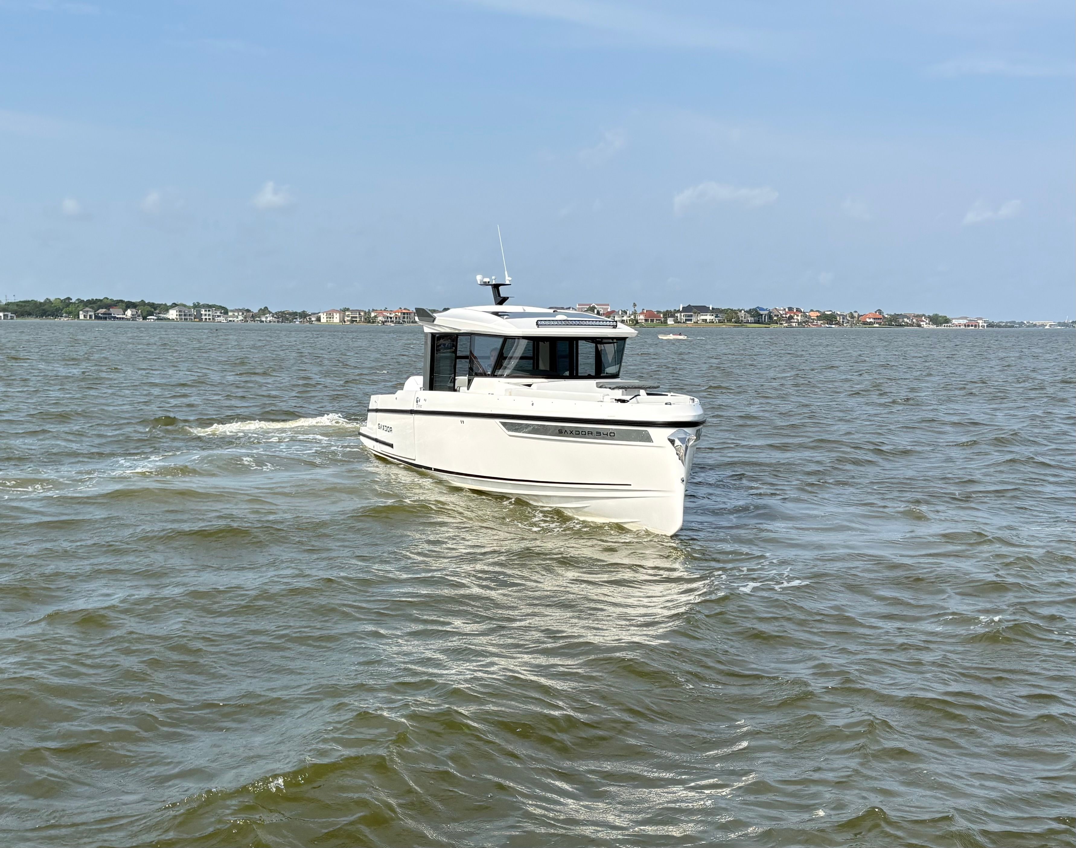 Saxdor 340 GTWA 2026 cruising on calm waters under sunny skies.