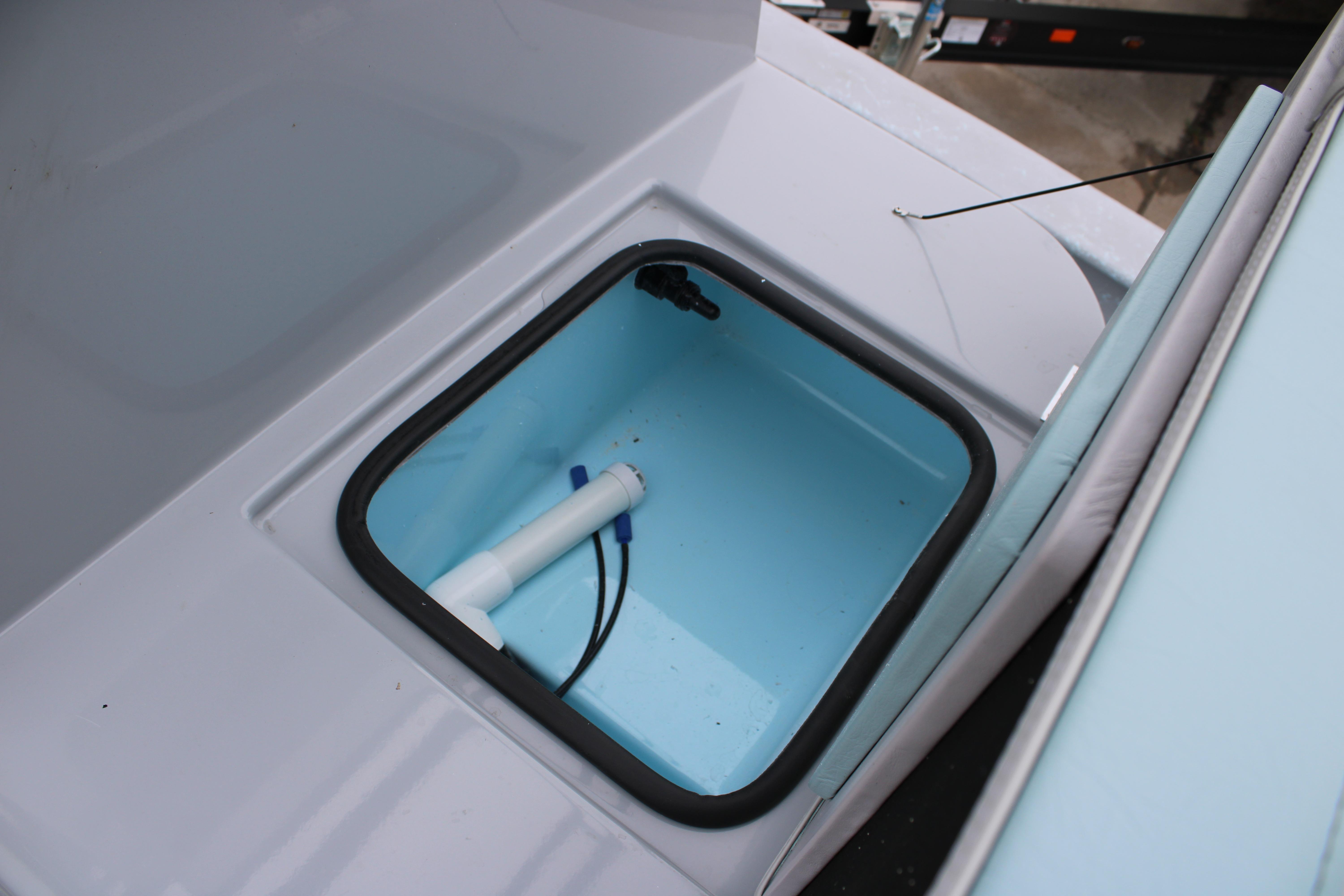 Livewell compartment on 2026 Freedom Boats 24 Defender, featuring a clean, blue interior.