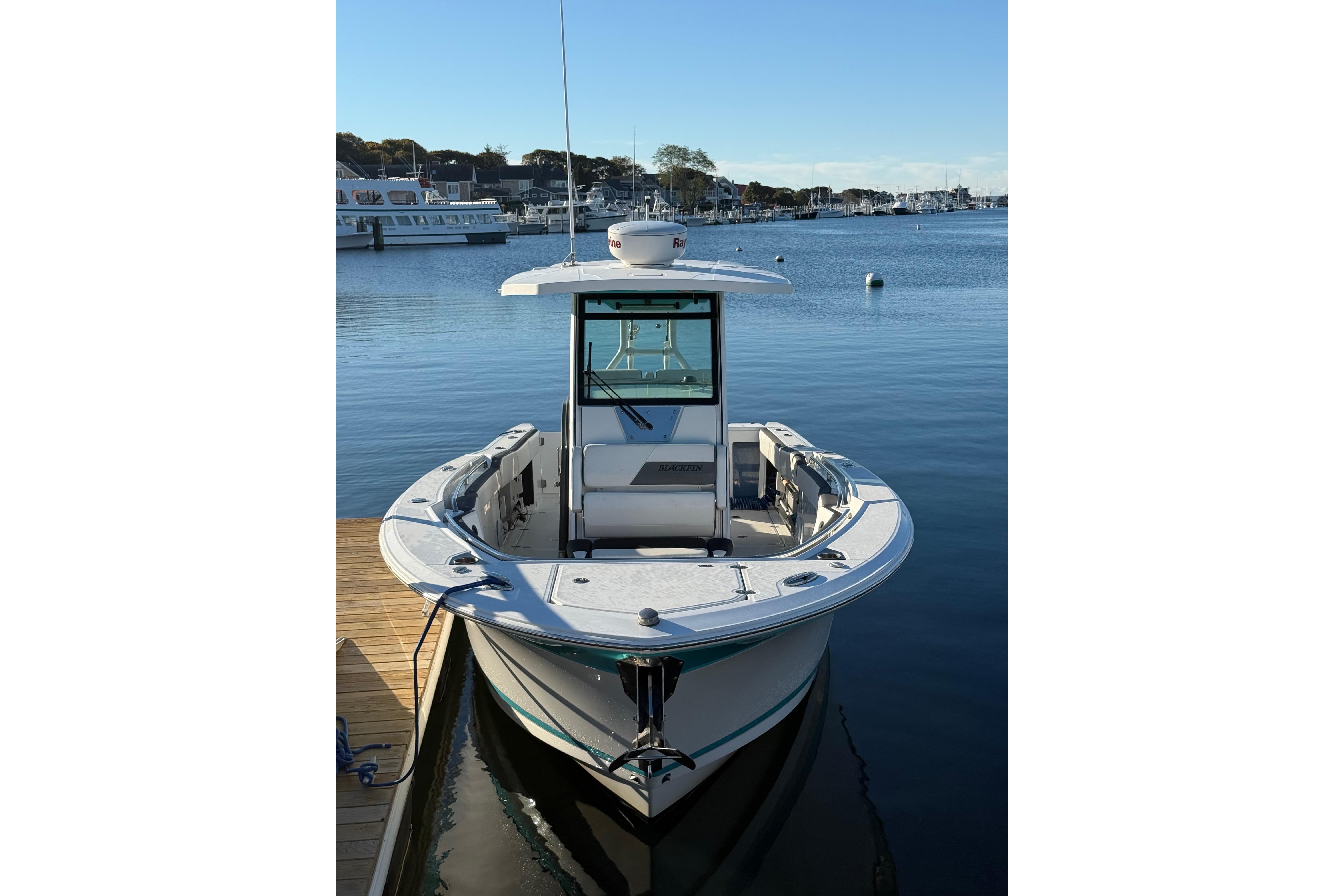 2018 Blackfin 272 CC boat docked in a serene marina setting.