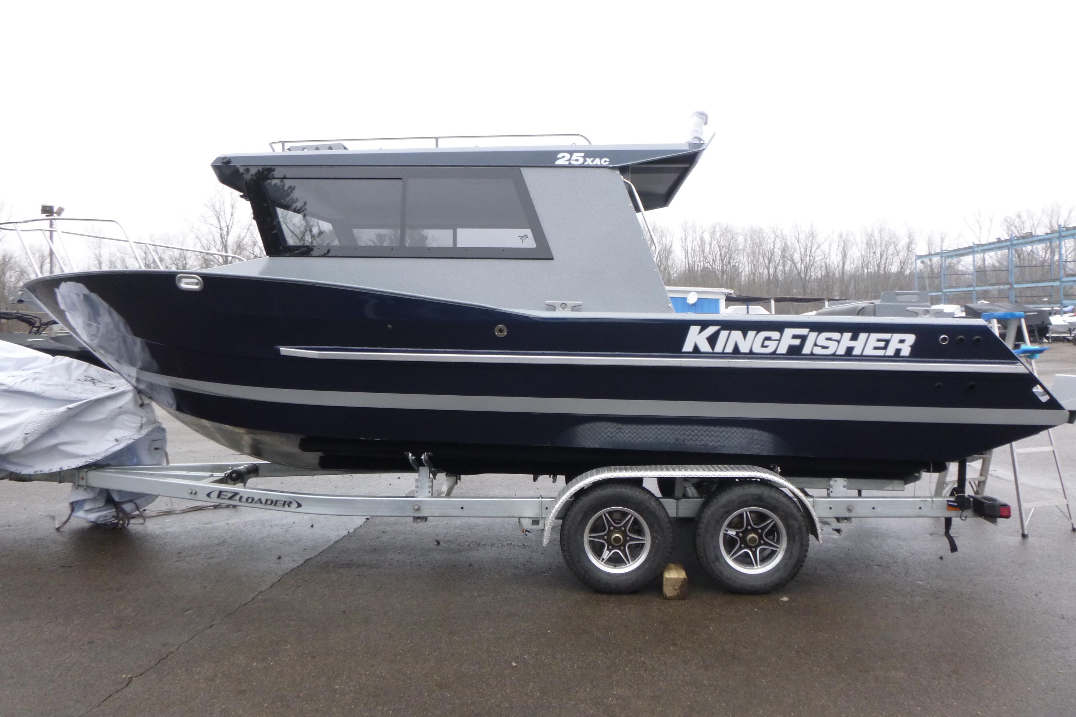2026 KingFisher 25 XAC boat on trailer, parked outdoors on a cloudy day.