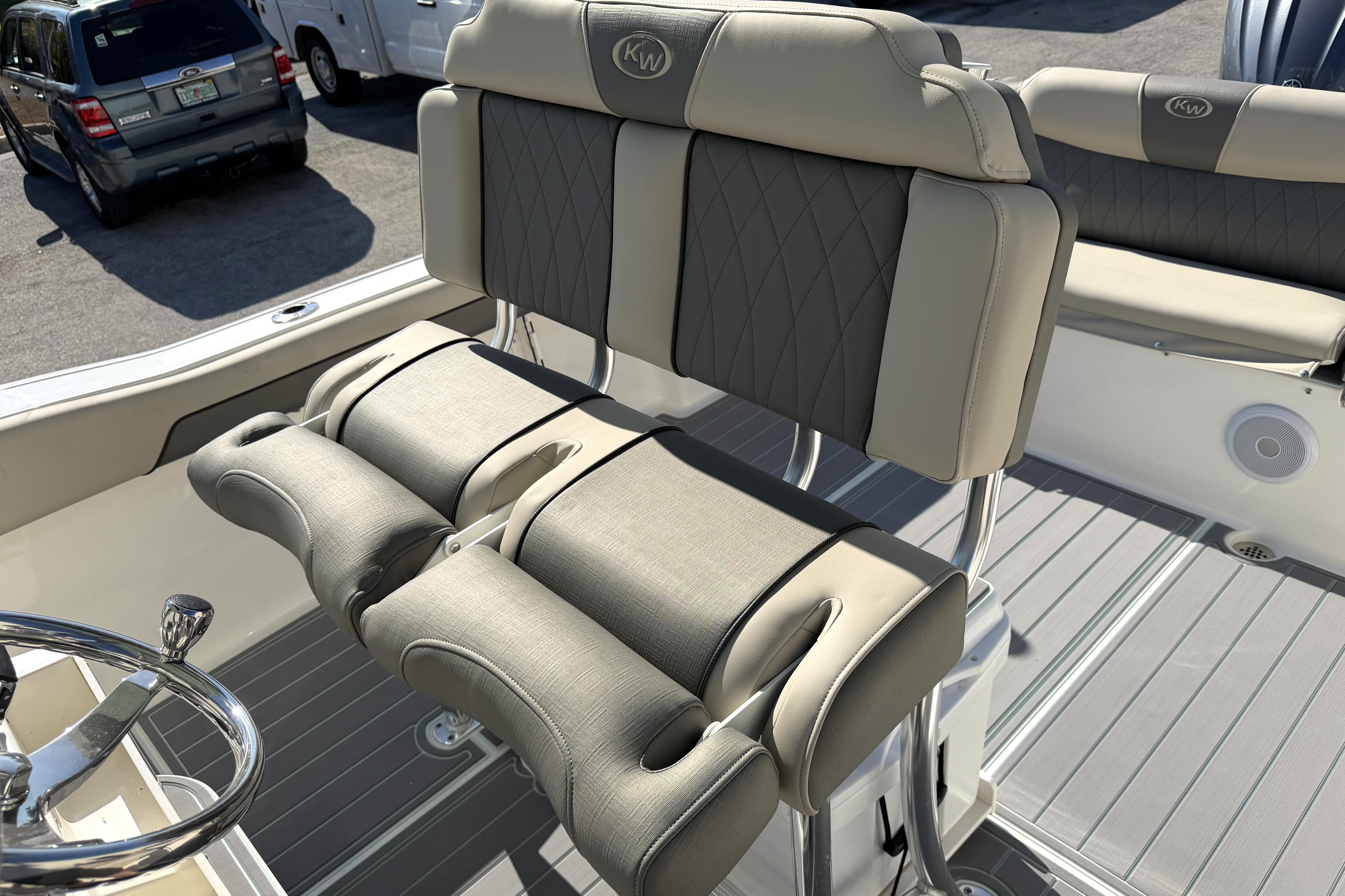 2025 Key West 239 FS boat interior with cushioned seating and steering wheel.