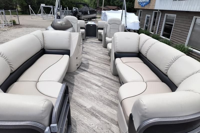 2017 Manitou 25 Oasis SE pontoon boat with spacious seating and elegant interior design.