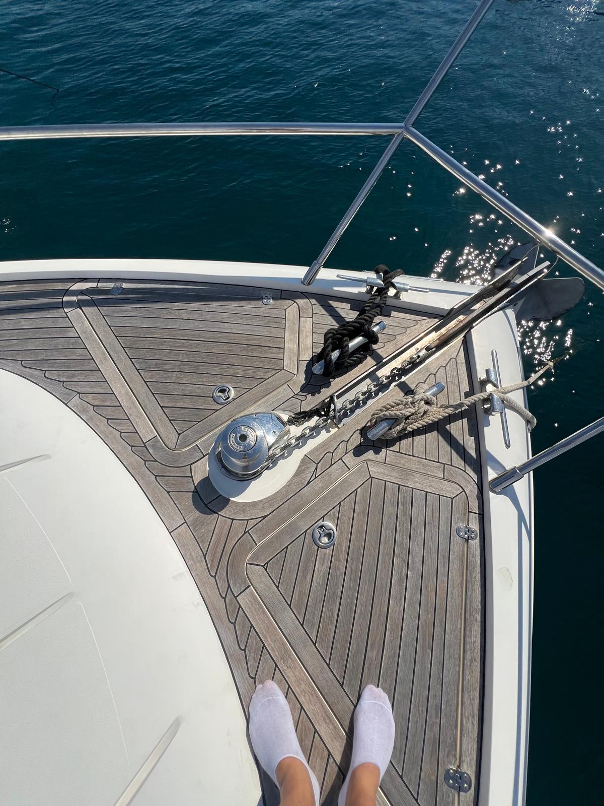 Bow of 2011 Princess V62 yacht with wooden deck and ocean view.