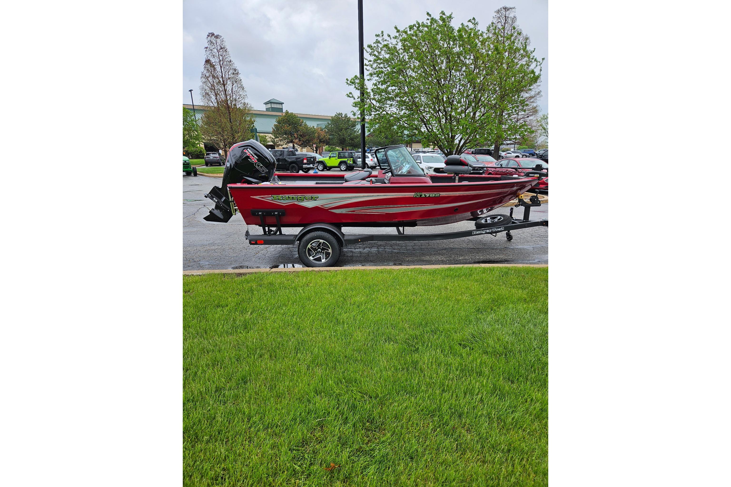 2026 Ranger VS1782SC Reata boat in vibrant red, parked on a trailer.