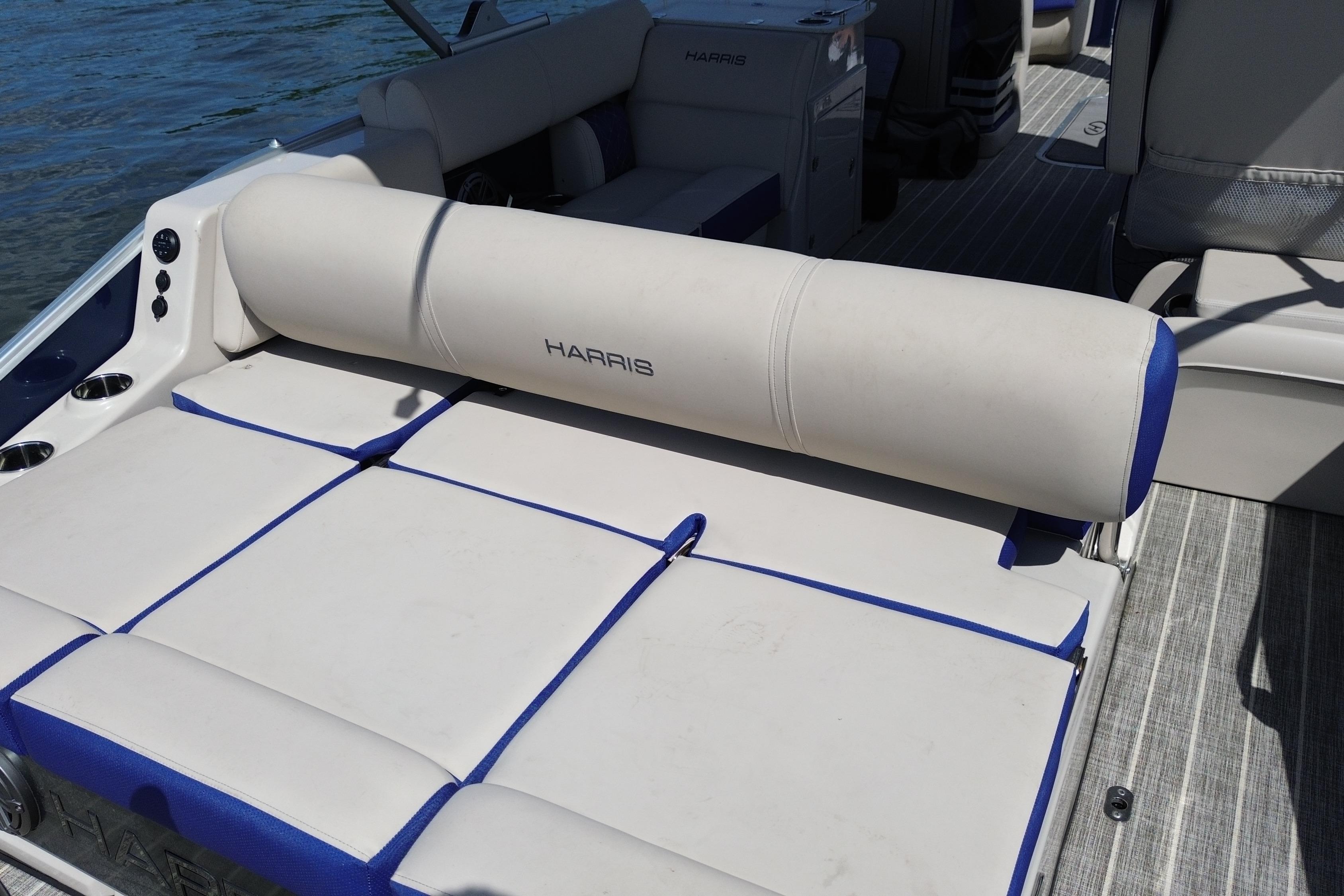 2022 Harris Grand Mariner 250 boat interior with cushioned seating and cup holders.