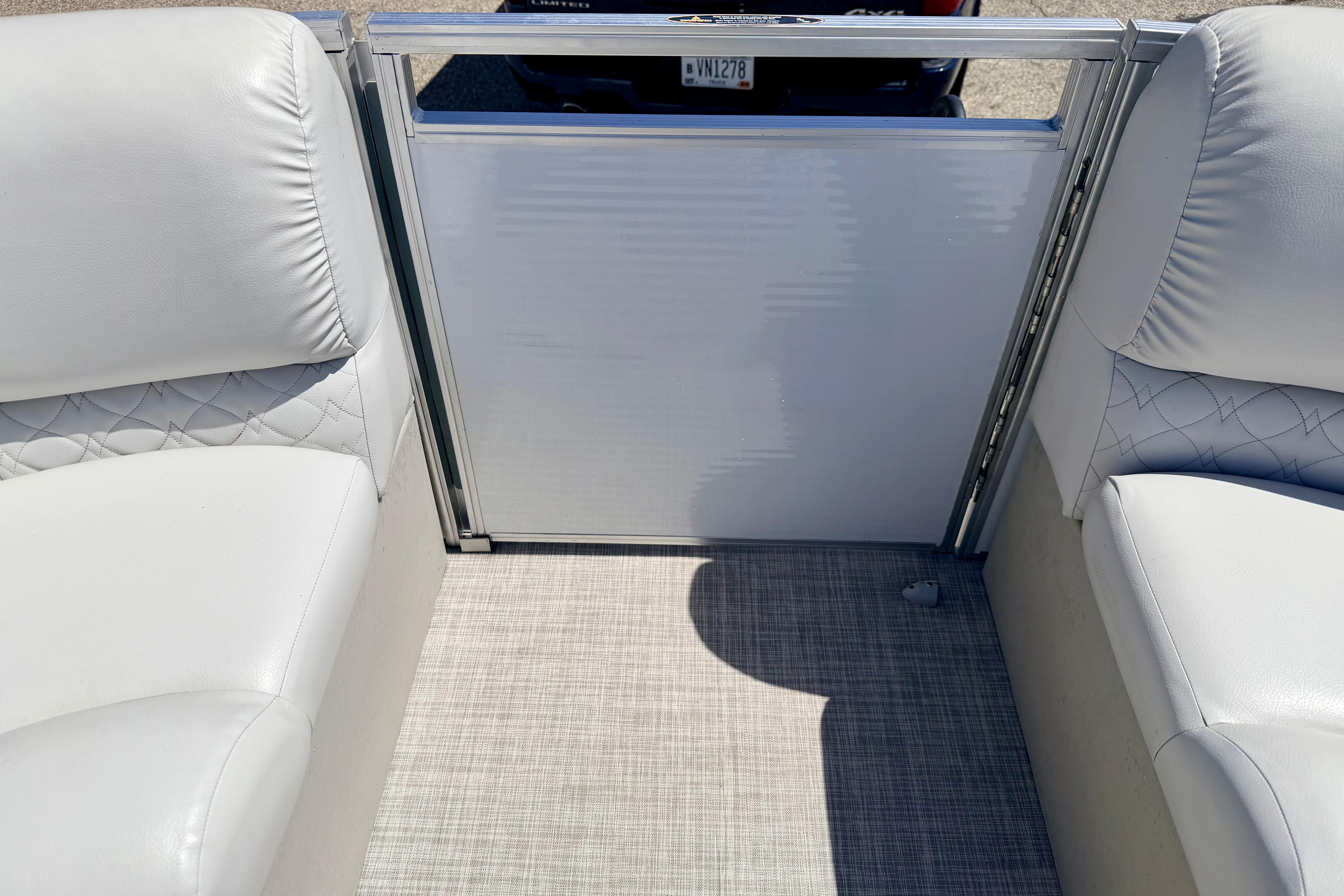 Interior of 2019 Crestliner 240 Rally DX CW boat with white seating and textured flooring.