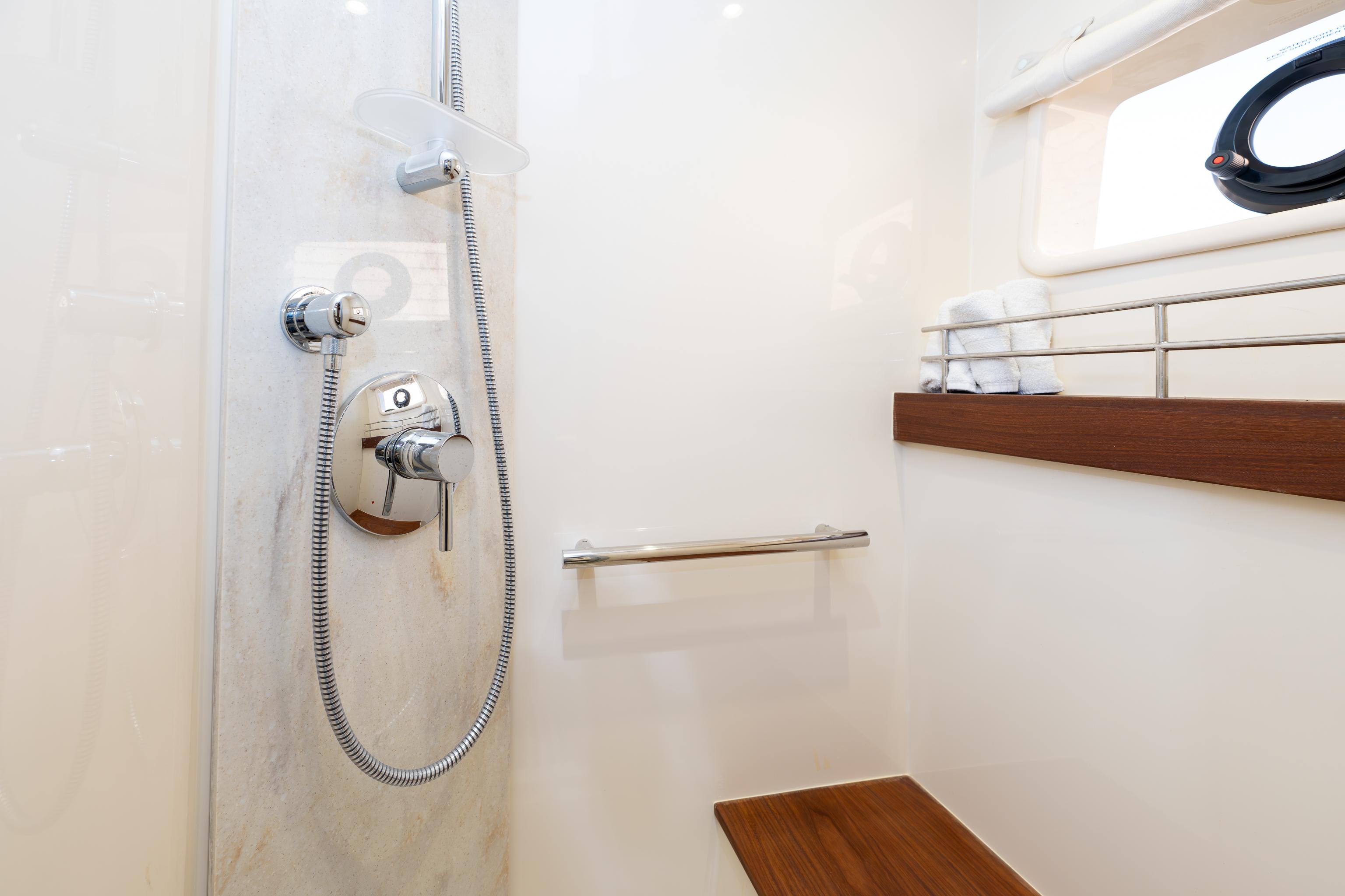 Shower area in 2014 Sea Ray 510 Fly yacht with modern fixtures and wooden accents.