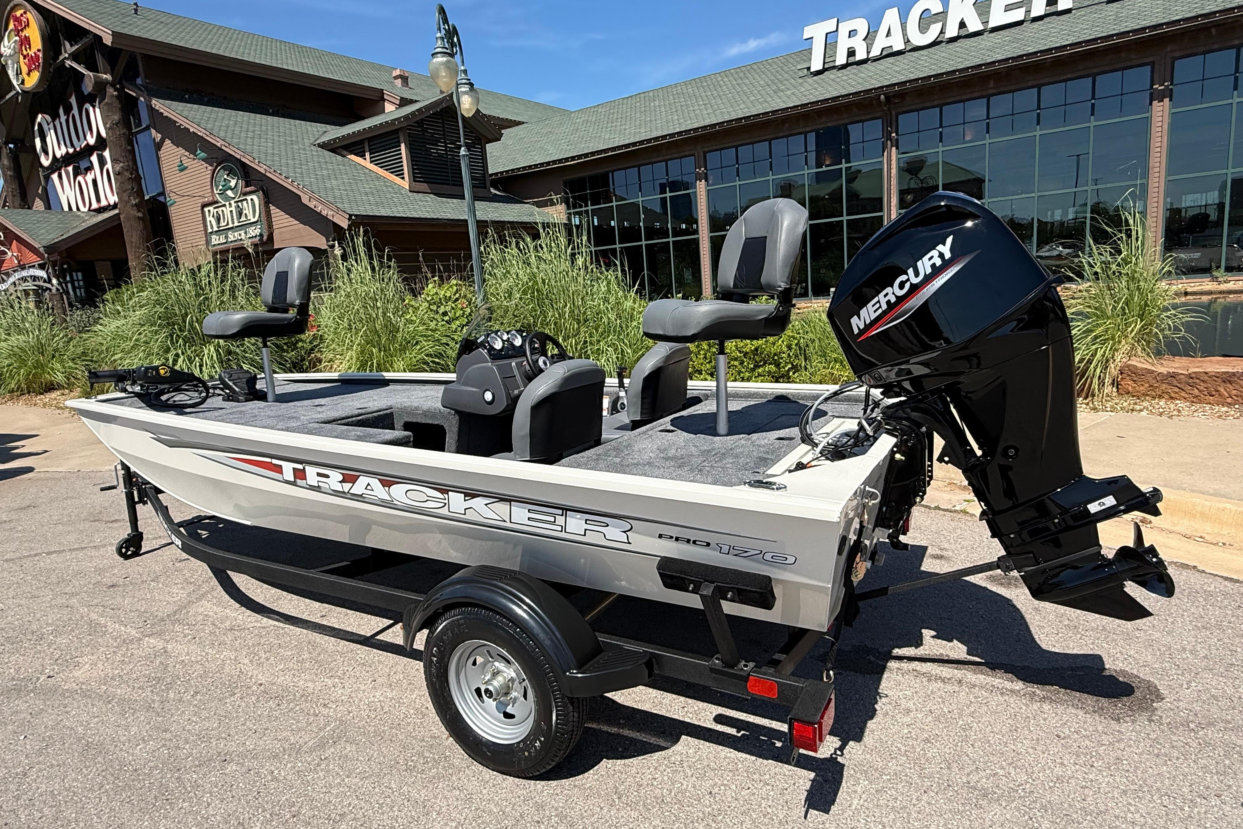 2026 Tracker Pro 170 boat with Mercury engine outside a store.