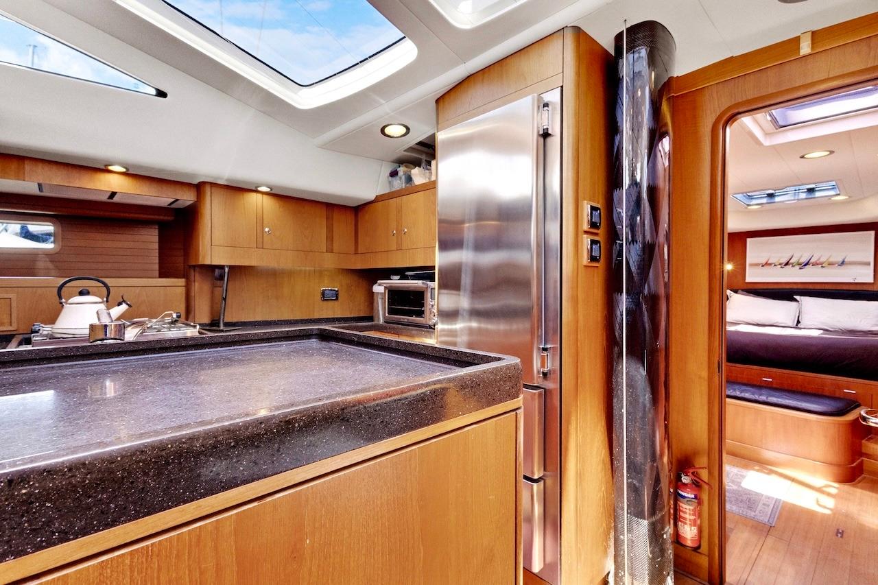 Luxurious interior of 2011 Southerly 57 RS yacht with modern kitchen and cozy cabin.