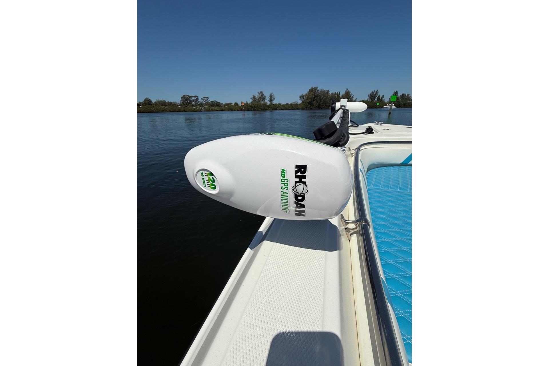 Custom Infusion 34 CC 2021 boat with Rhodan GPS anchor, blue seating, on calm water.