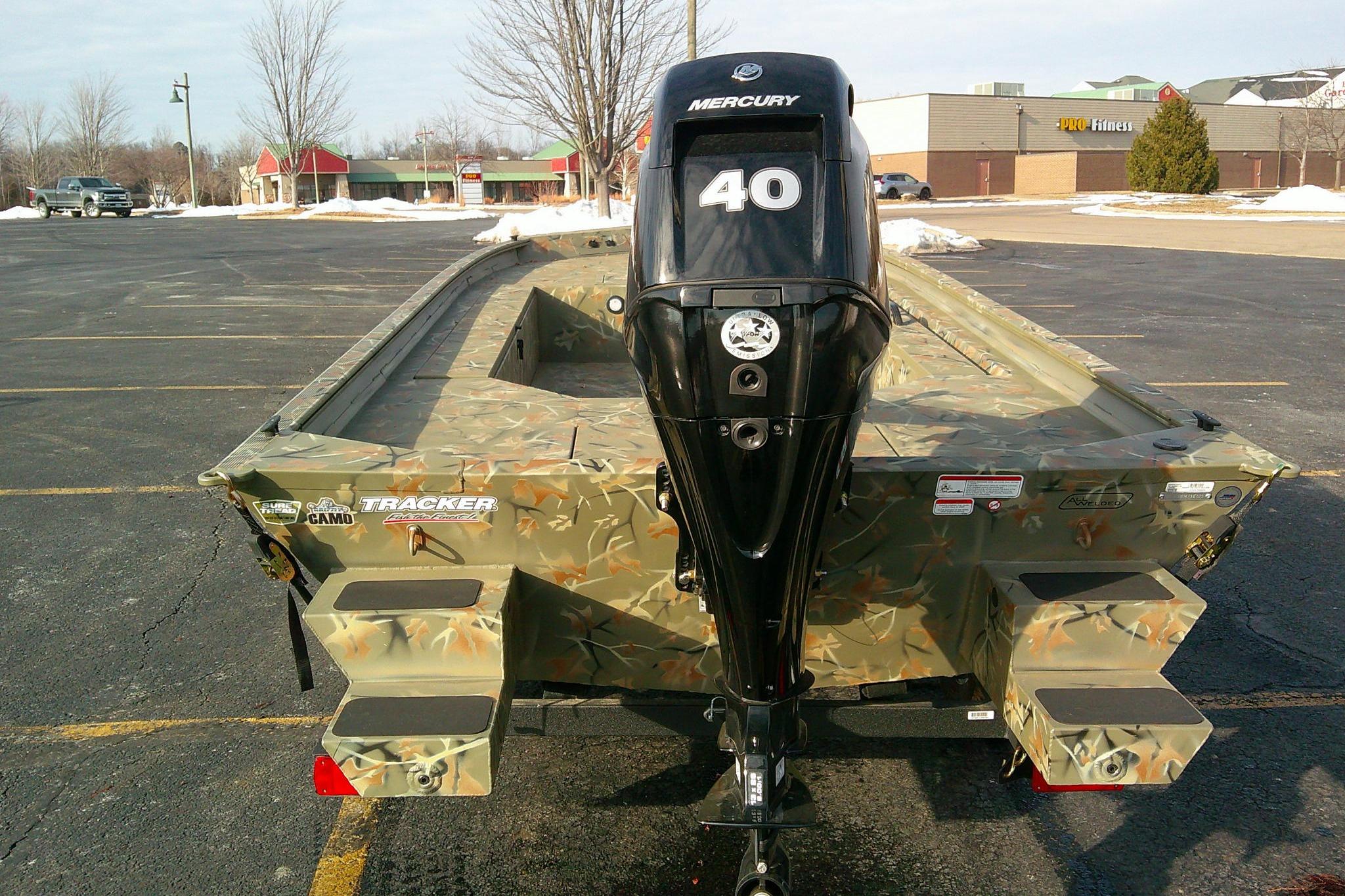 2025 Tracker Grizzly 1654 T Sportsman boat with Mercury 40 engine in a parking lot.