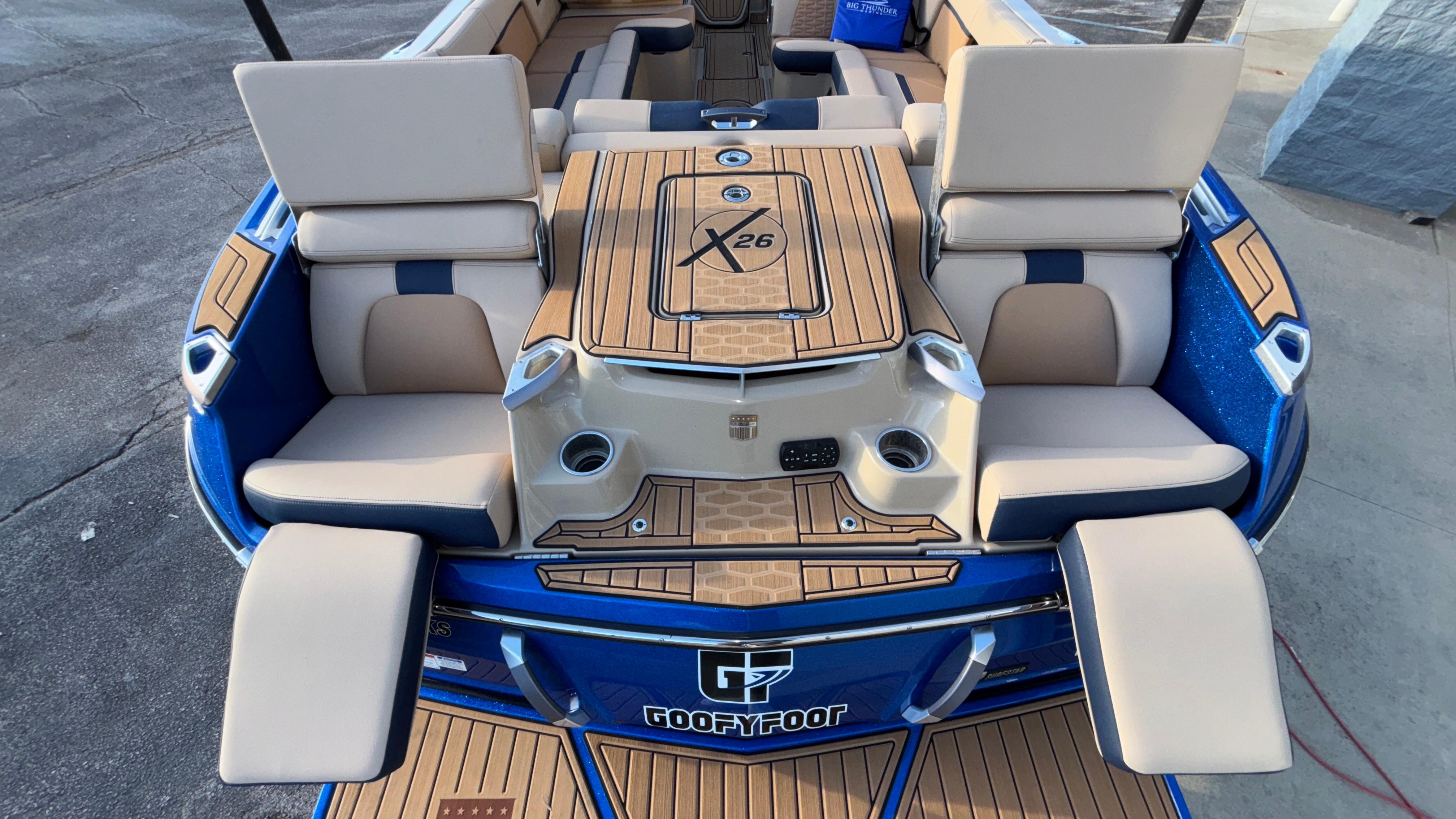 2022 MasterCraft X26 boat interior with luxurious seating and teak-style flooring.