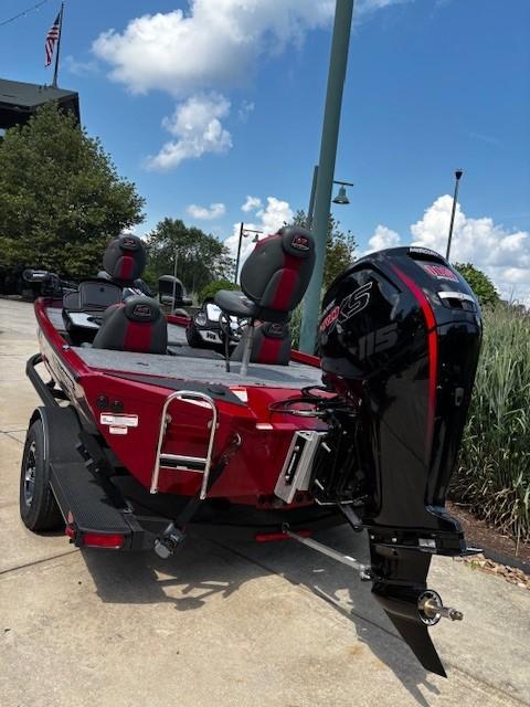 2025 Ranger RT188P boat with powerful outboard motor, parked outdoors under a clear sky.