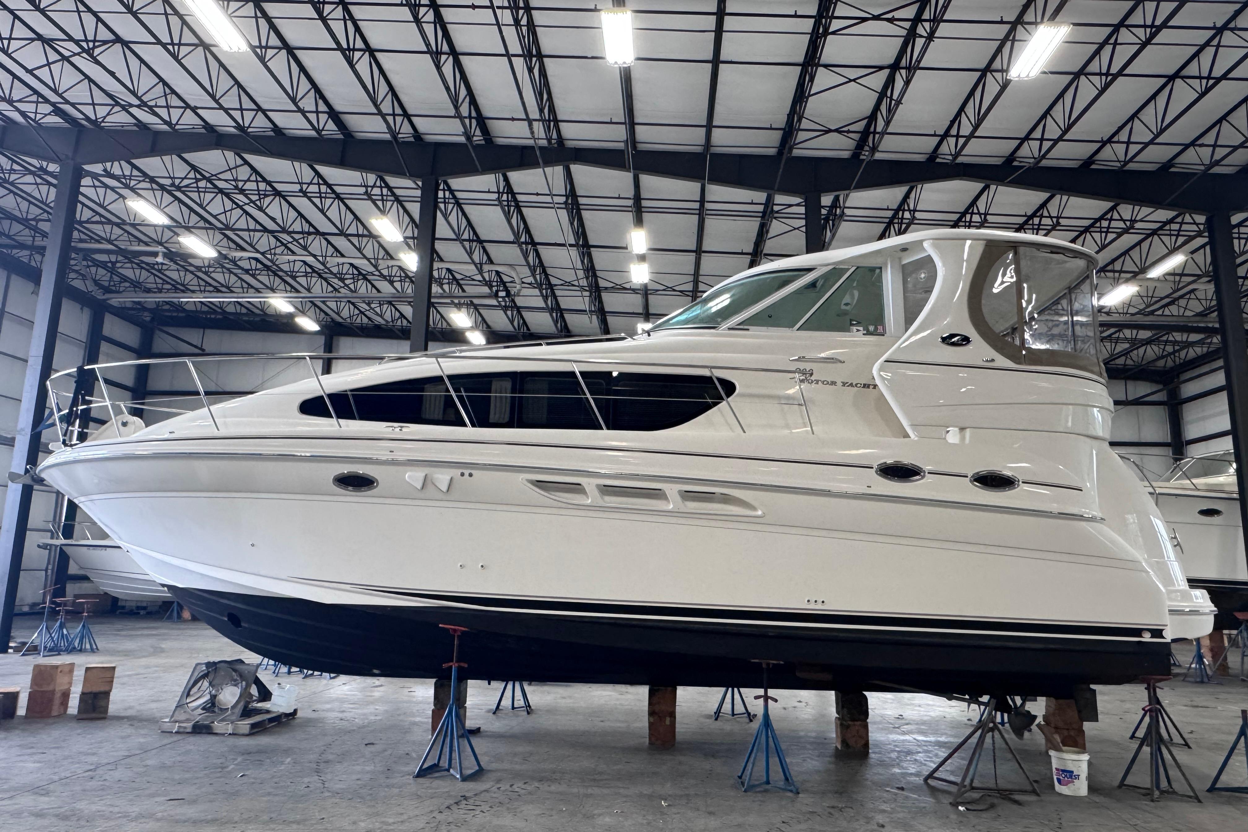 2004 Sea Ray 390 Motor Yacht in a warehouse, elevated on stands.