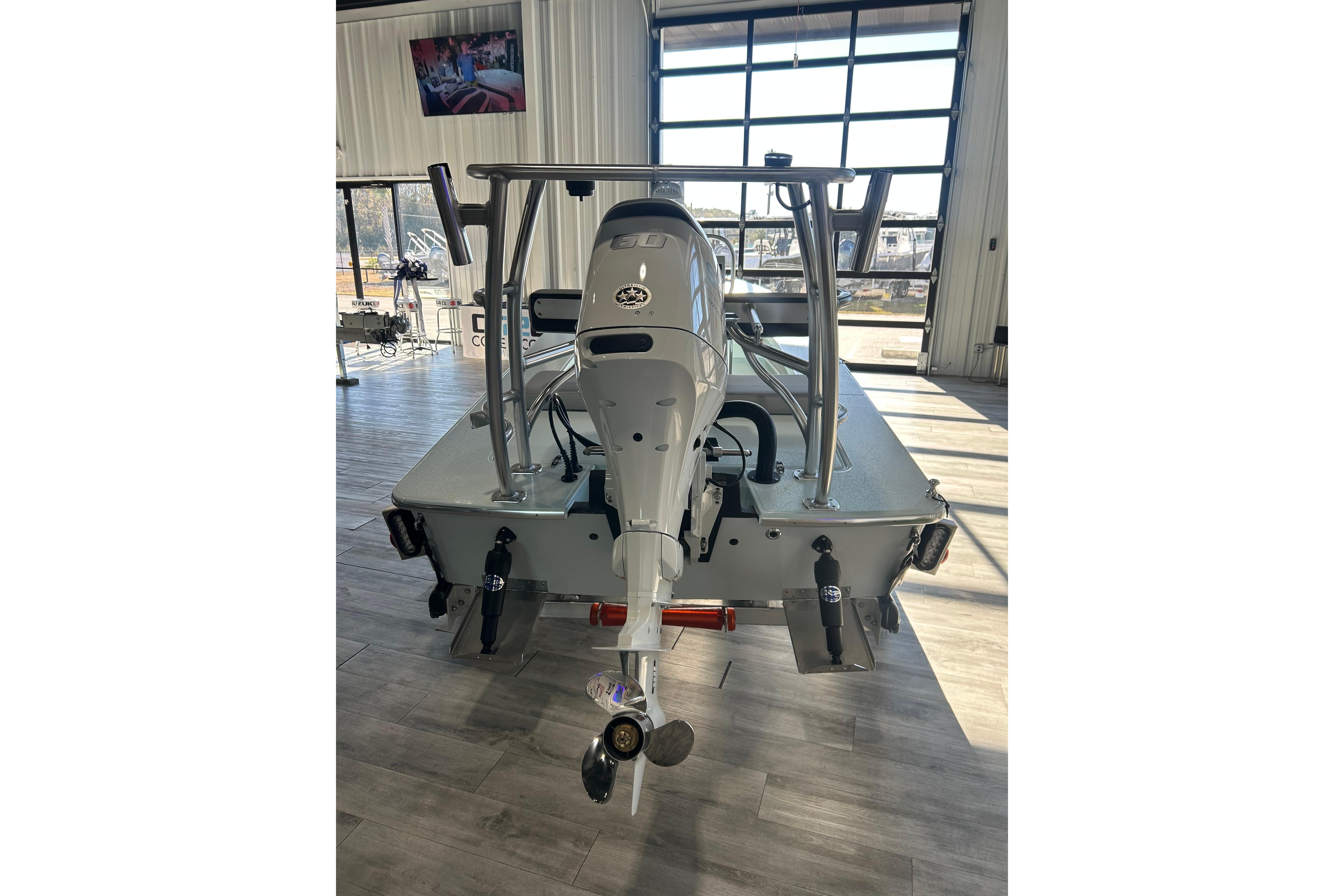 2026 East Cape Evo 17X boat in showroom, rear view with motor and equipment.