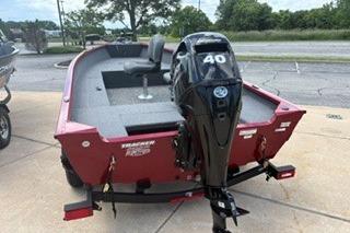 2025 Tracker Super Guide V-16 T boat with 40 HP motor, parked on pavement.