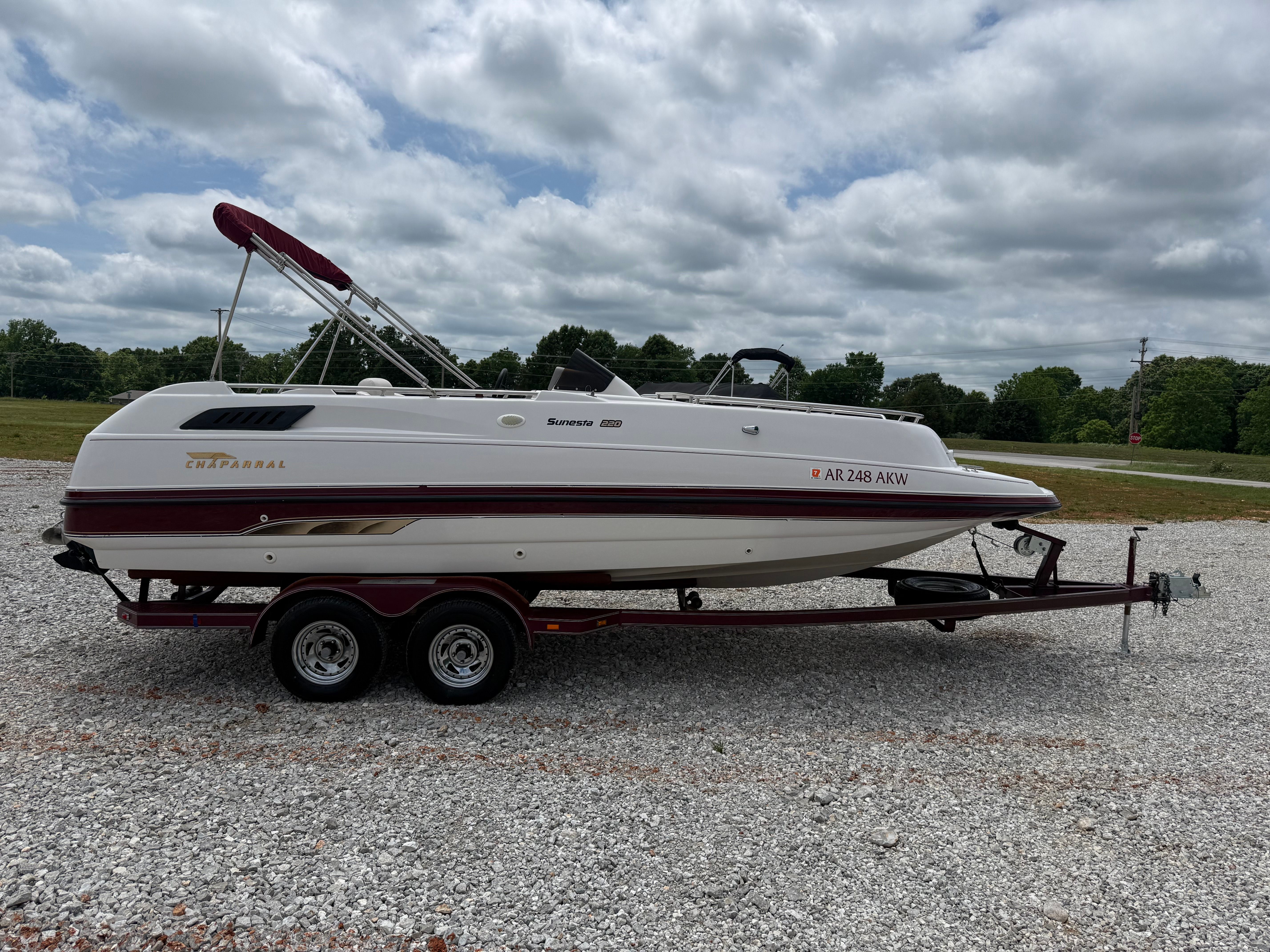 A 1994 Chaparral Sunesta 220 on a trailer in a gravel lot.