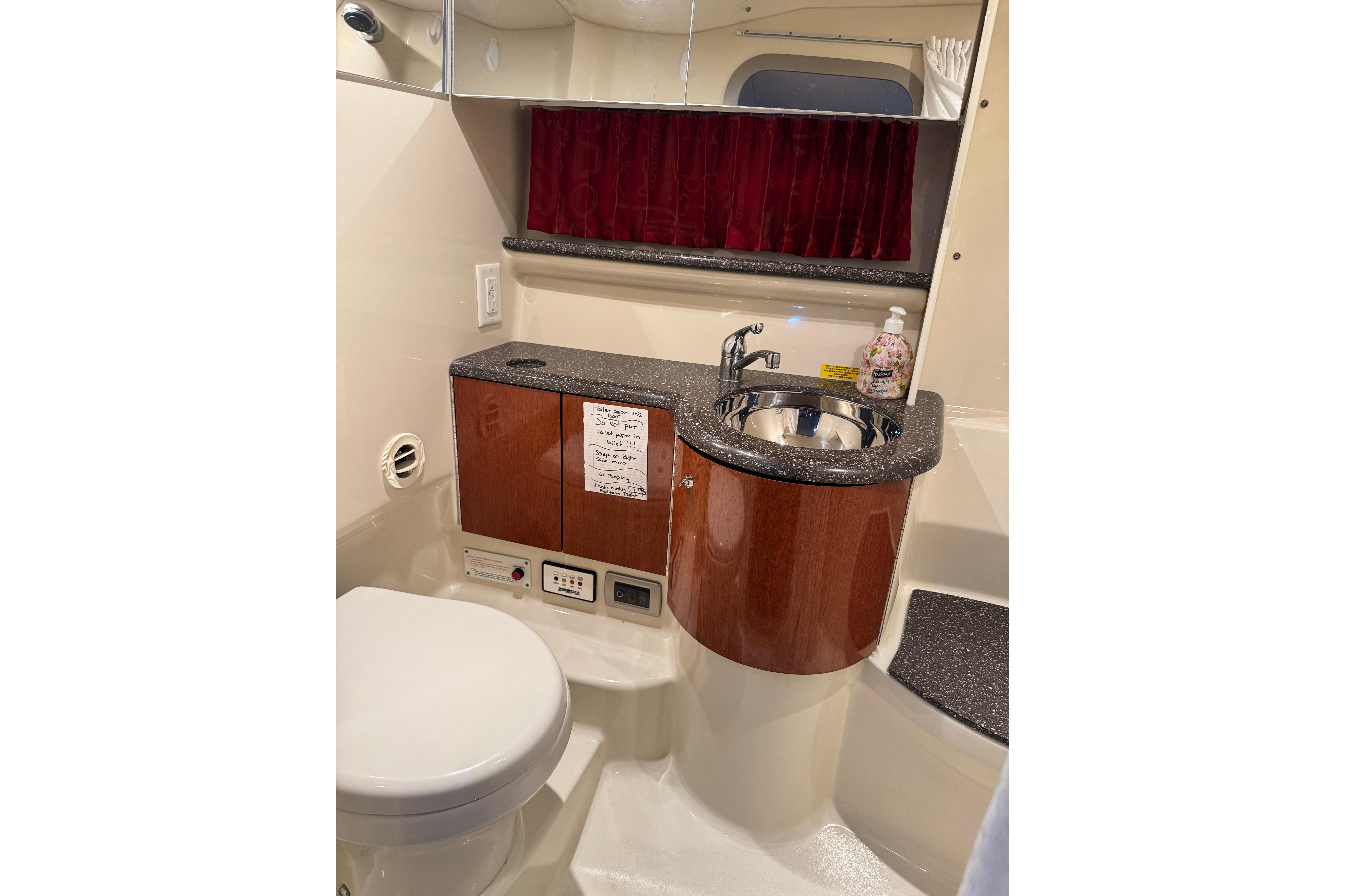 2008 Formula 400 Super Sport yacht bathroom with sink, toilet, and storage cabinet.