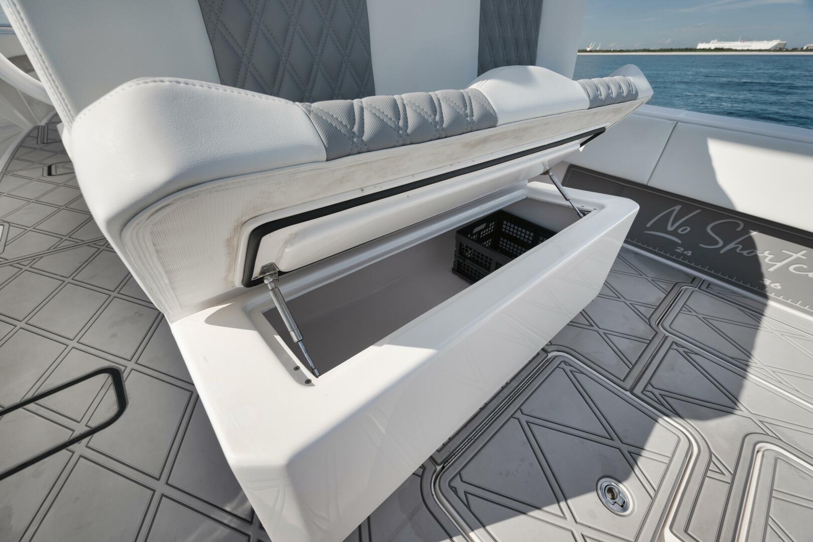 2020 Invincible Open Fisherman boat with open storage compartment on deck.