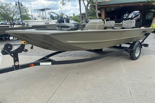 2026 Tracker Grizzly 1754 SC boat on trailer, parked outdoors, showcasing sleek design.