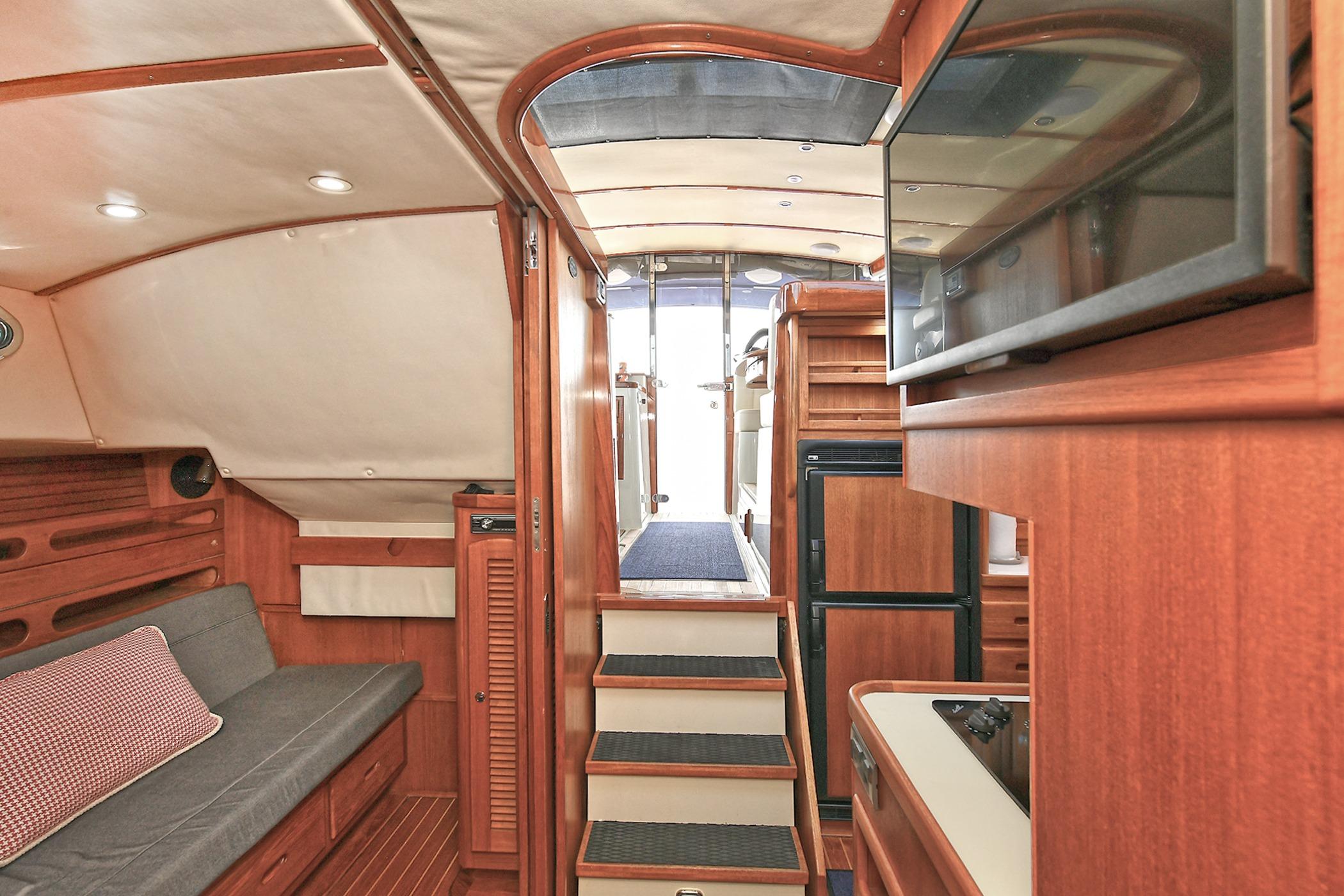 Interior of 2005 San Juan Downeast Express yacht with wooden finishes and modern amenities.