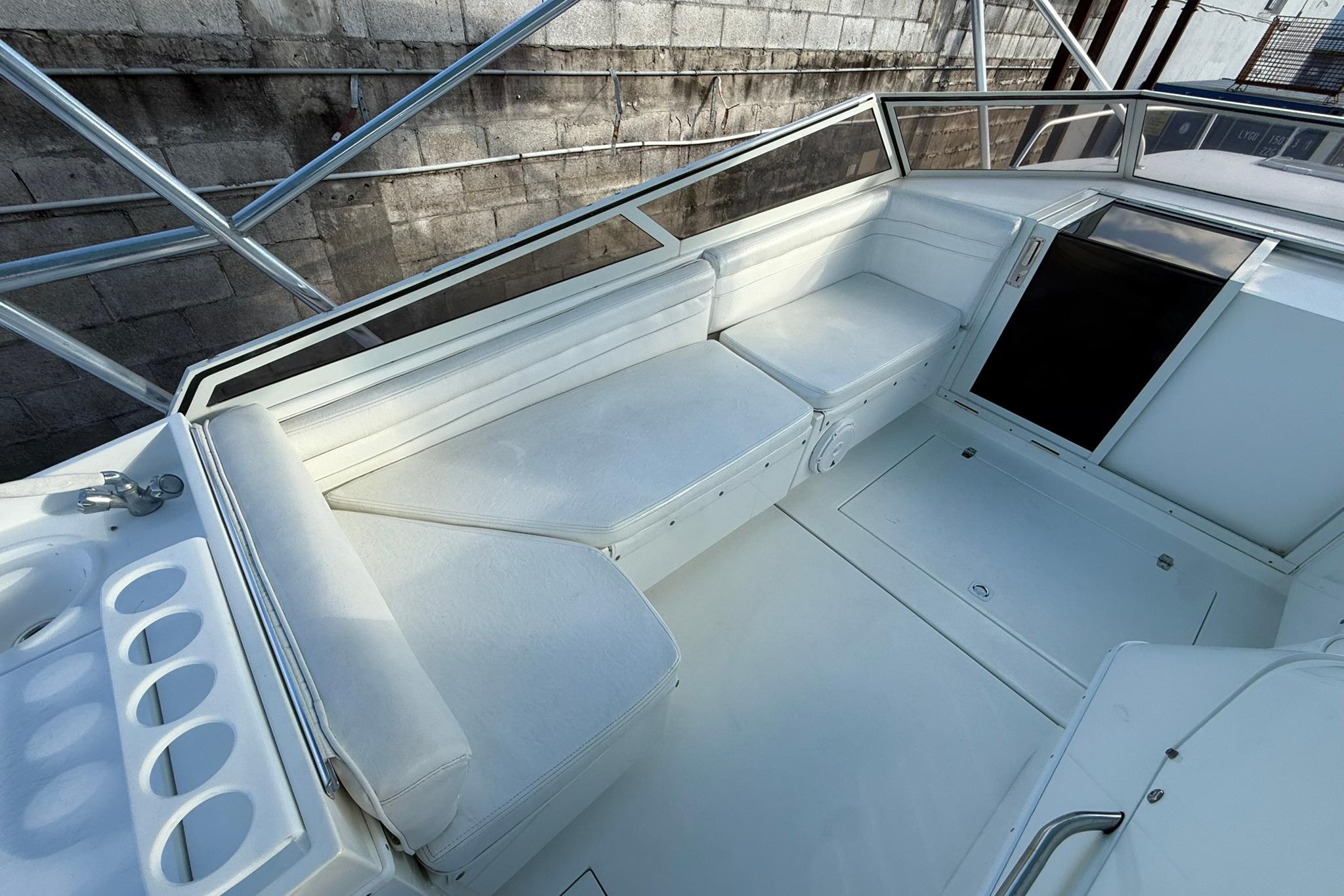 1998 Contender 35 Express boat interior with white seating and storage compartments.