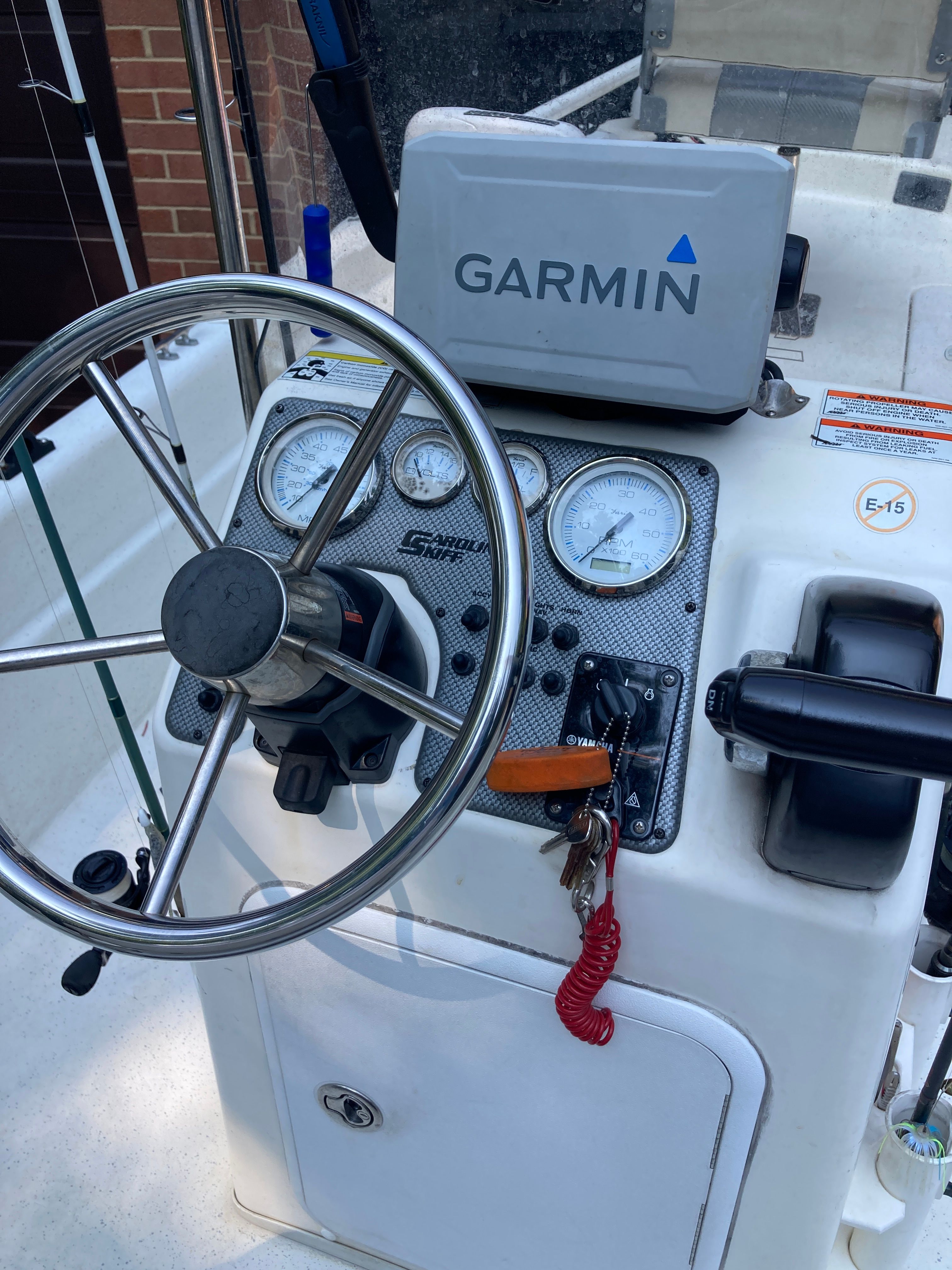 The image shows the helm of a Carolina Skiff JVX16CC boat with Garmin navigation.