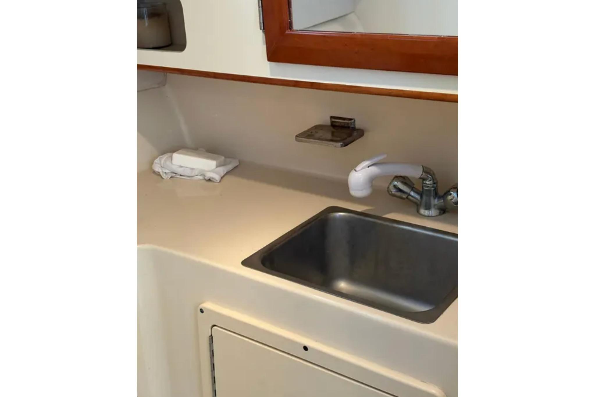 Compact sink area in 2005 Albin 28 Tournament Express boat interior.