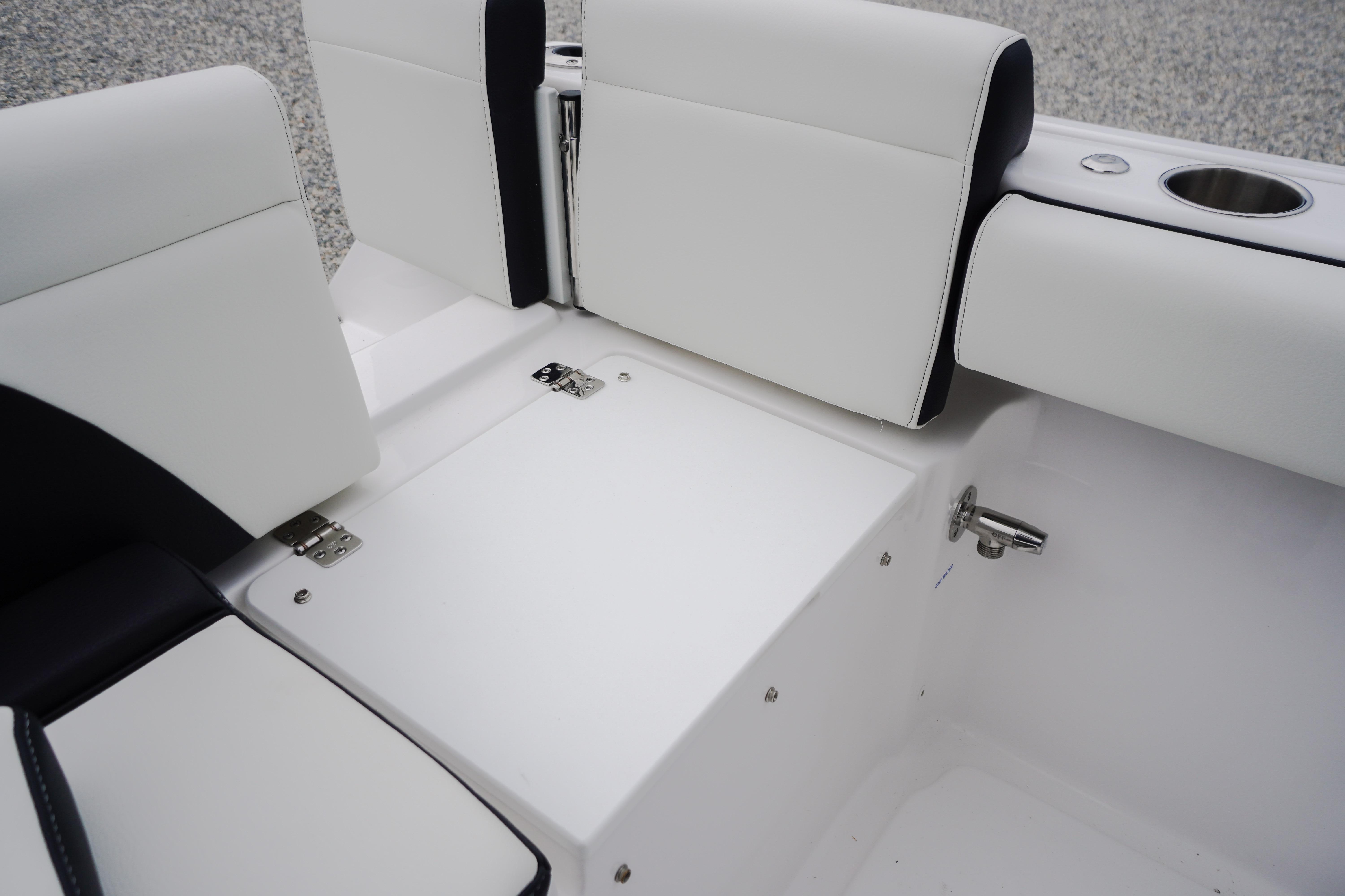 2026 Tidewater 232 SS boat interior with white cushioned seating and stainless steel cup holder.