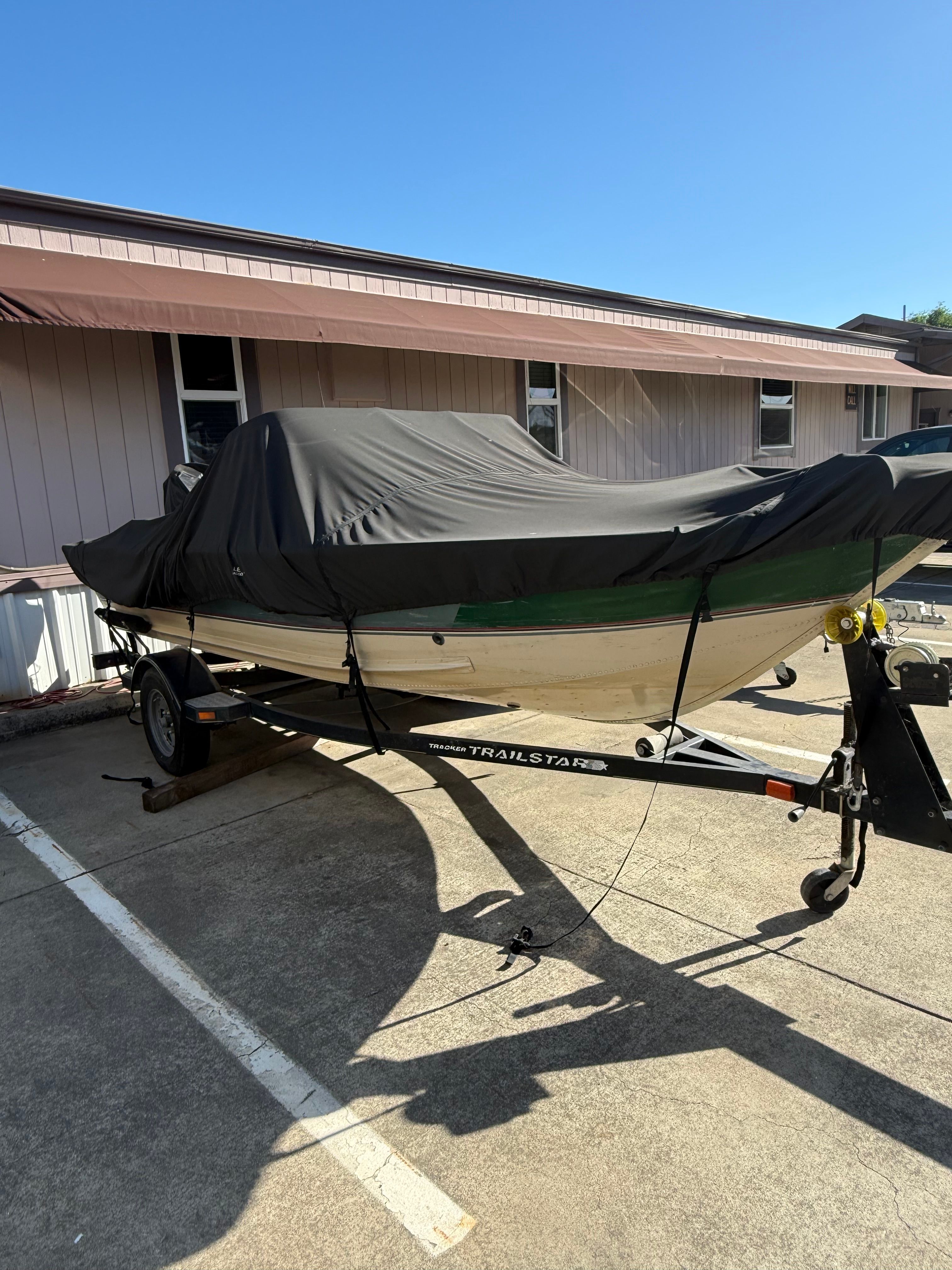 2002 Bass Tracker Pro Deep V-16 Combo covered on trailer.