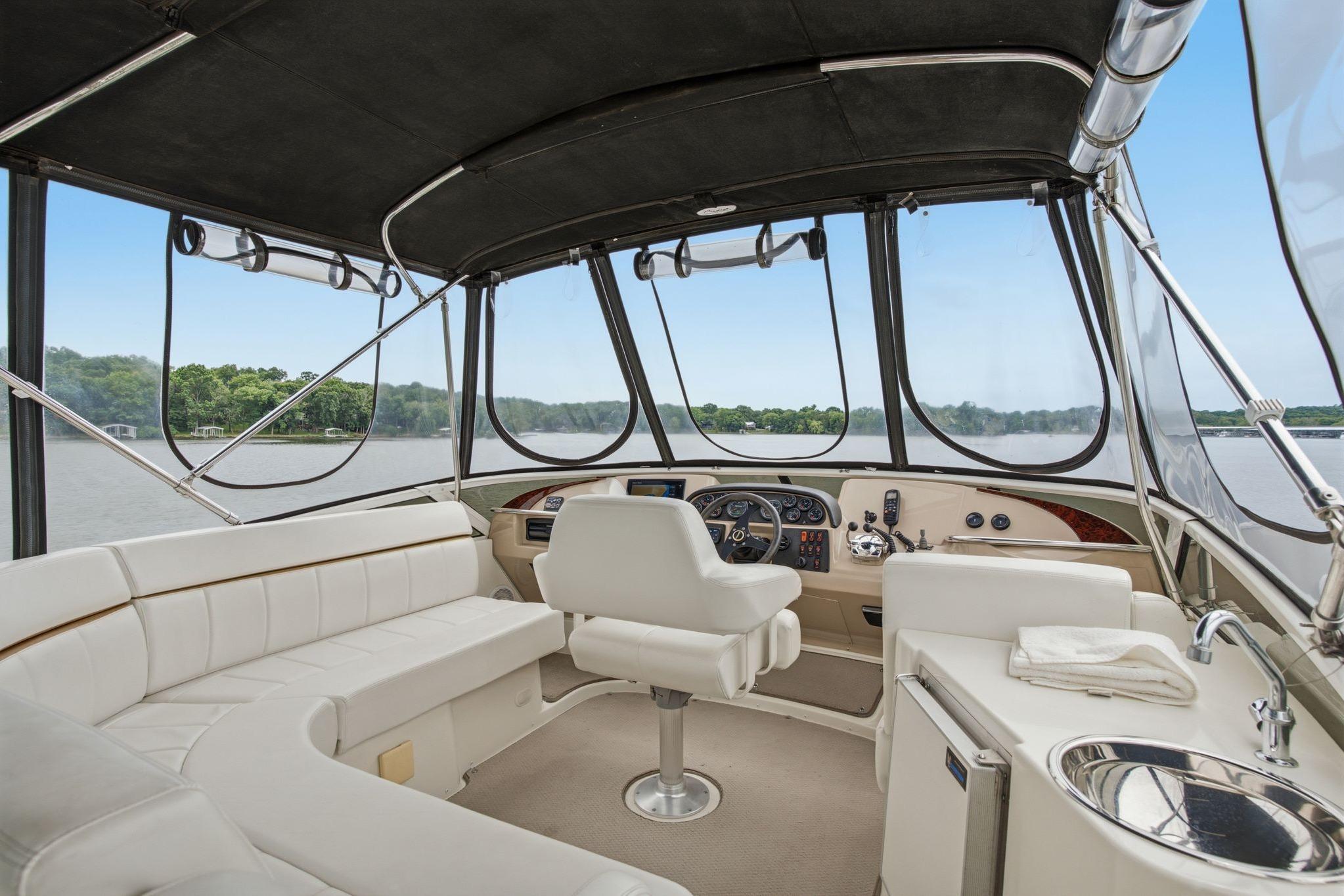 Interior of 2005 Carver 39 Motor Yacht with helm, seating, and panoramic windows.