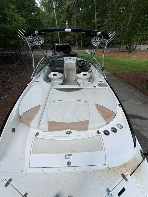 A 2007 Rinker 226 Captiva Bowrider with white and beige interior, parked on a trailer.