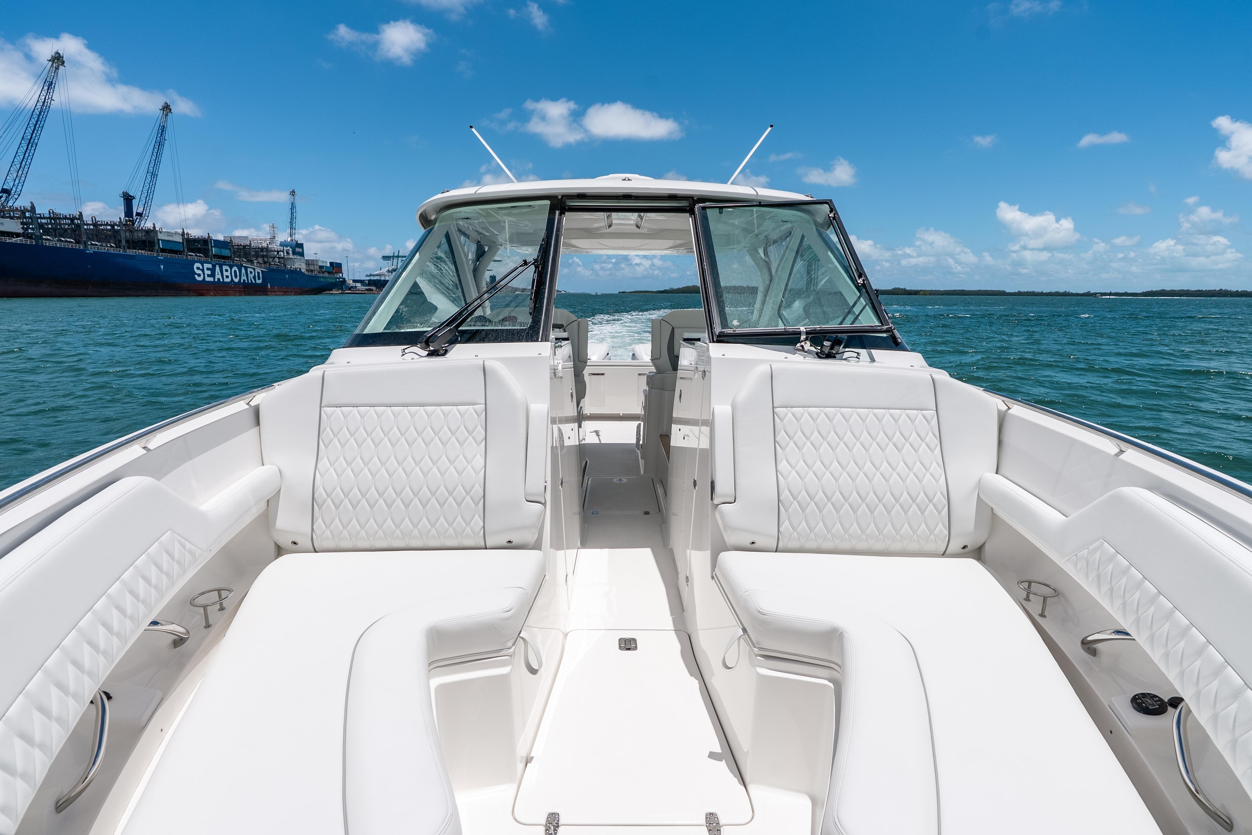 2026 Pursuit DC 326 Dual Console boat on open water, featuring luxurious seating.
