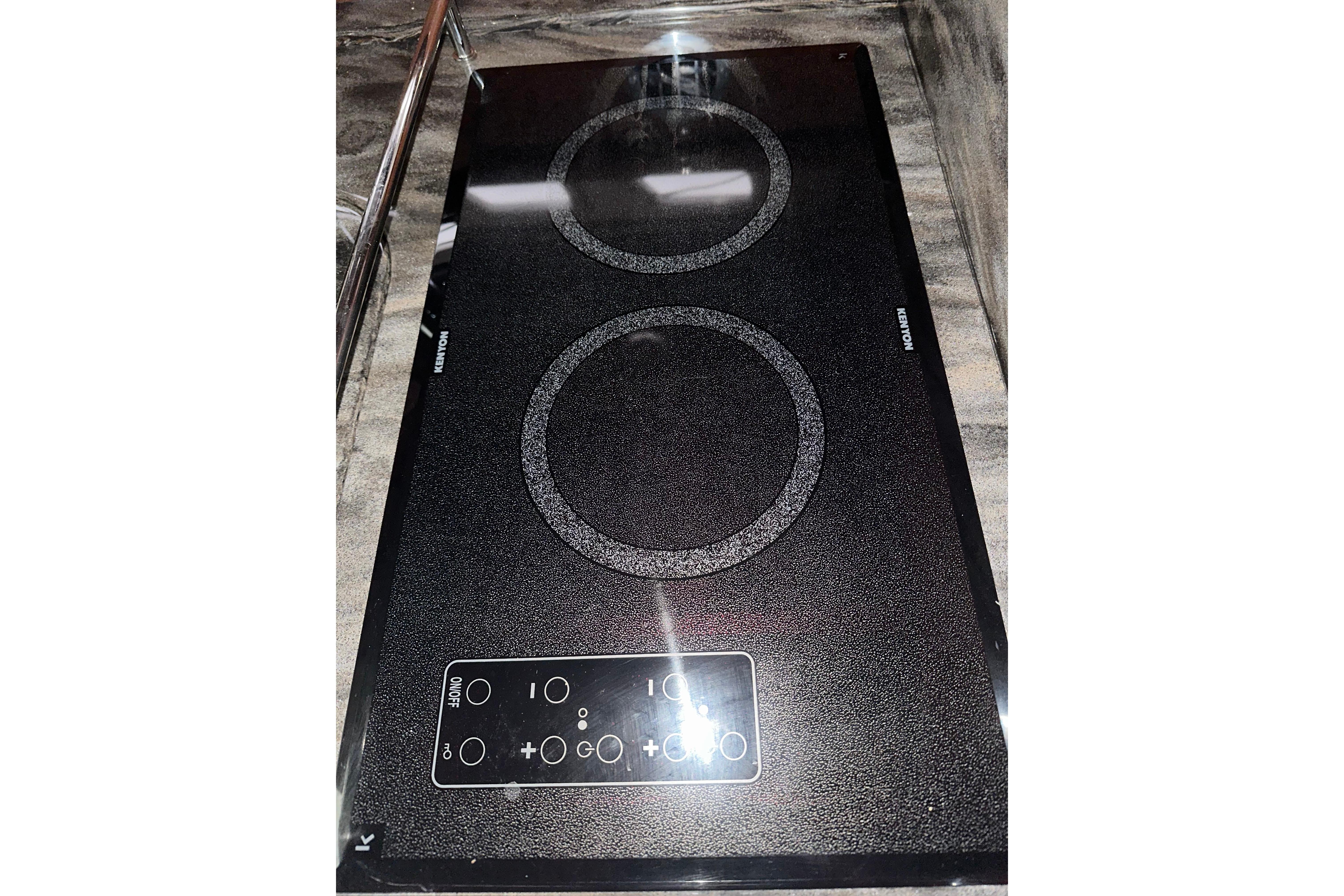 Ceramic cooktop on 2012 Sea Ray 390 Sundancer yacht, featuring dual burners and touch controls.