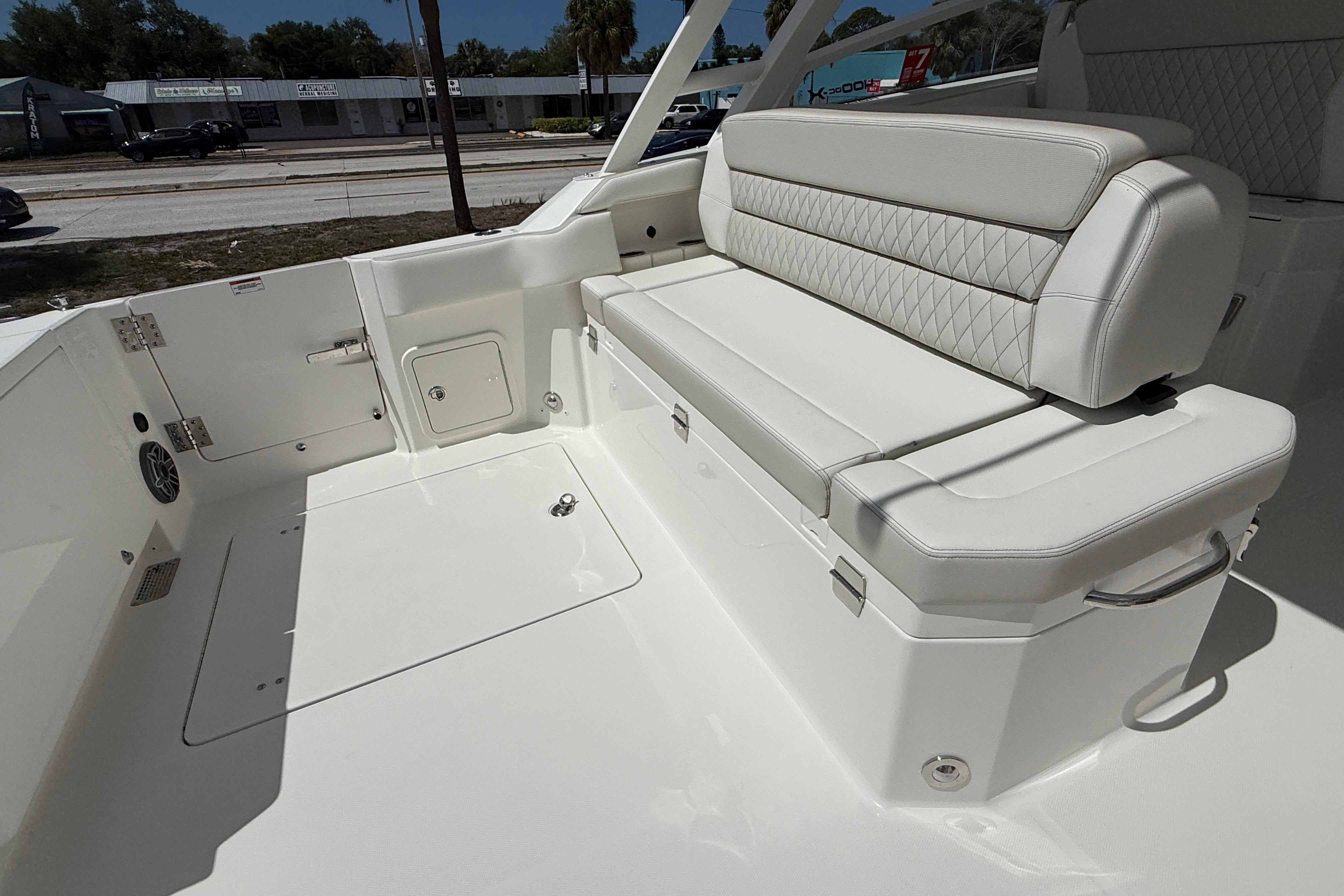 2026 World Cat 400 DC-X Island boat interior with white cushioned seating.