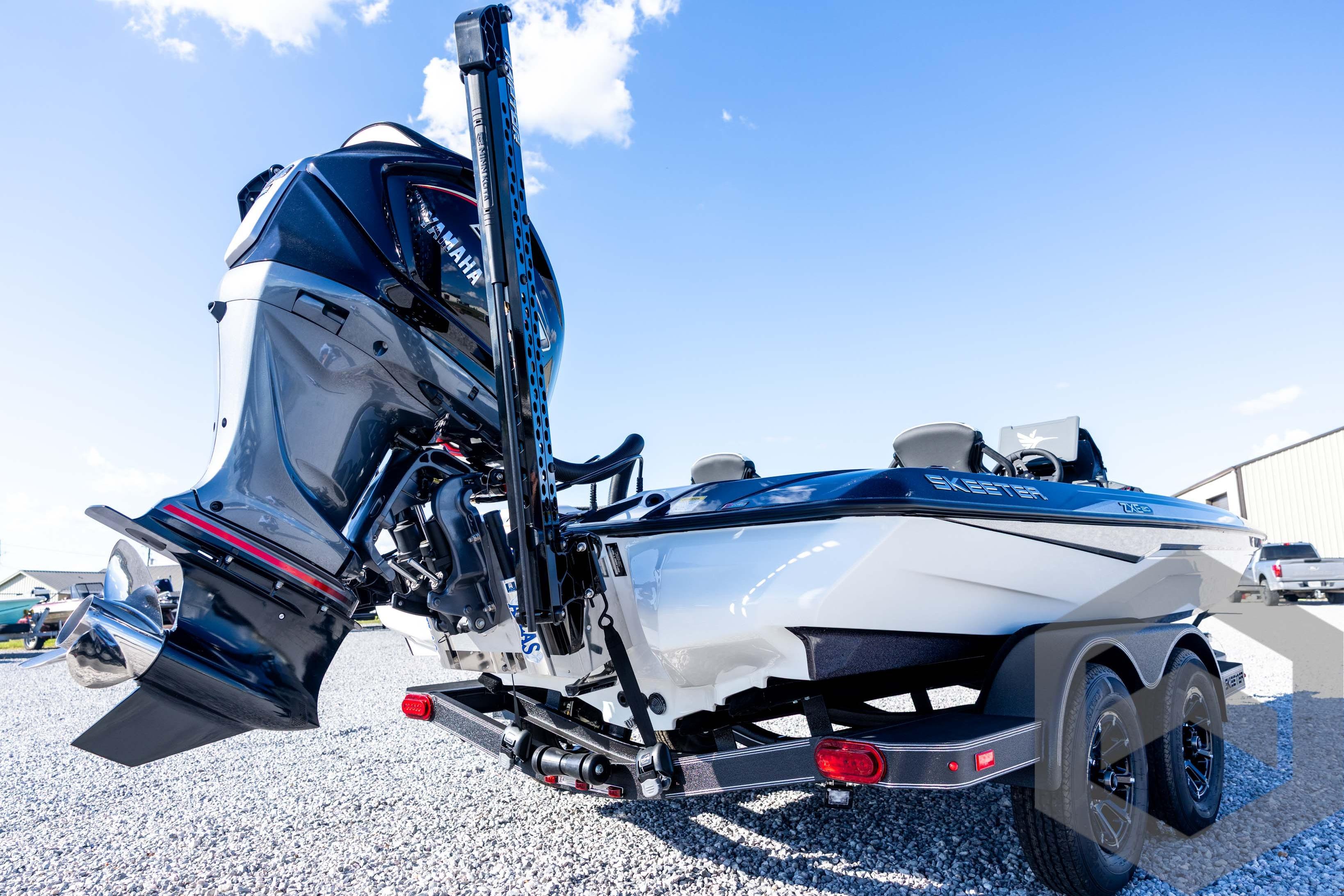 2026 Skeeter ZXE20 boat with Yamaha outboard motor, parked on gravel under blue sky.