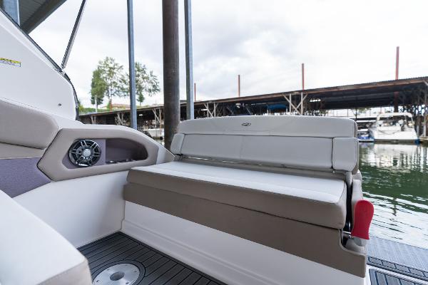2016 Regal 28 Express boat interior with cushioned seating and speaker, docked by the water.
