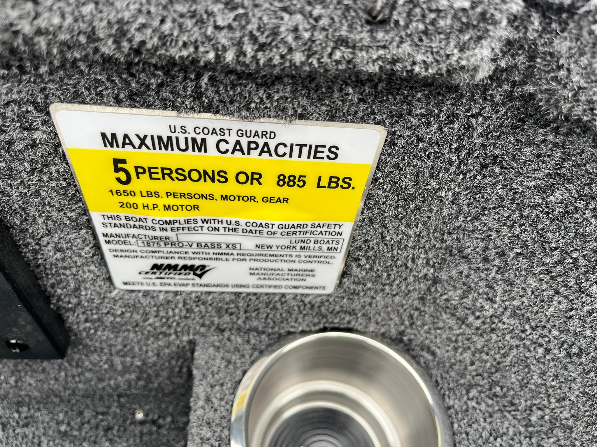 U.S. Coast Guard capacity label on 2026 Lund 1875 Pro-V Bass XS boat.
