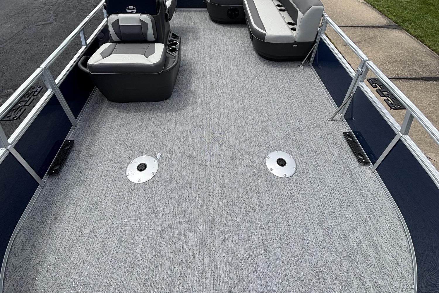 2026 Sun Tracker Bass Buggy 16 XL Select pontoon boat interior with seating and carpeted deck.