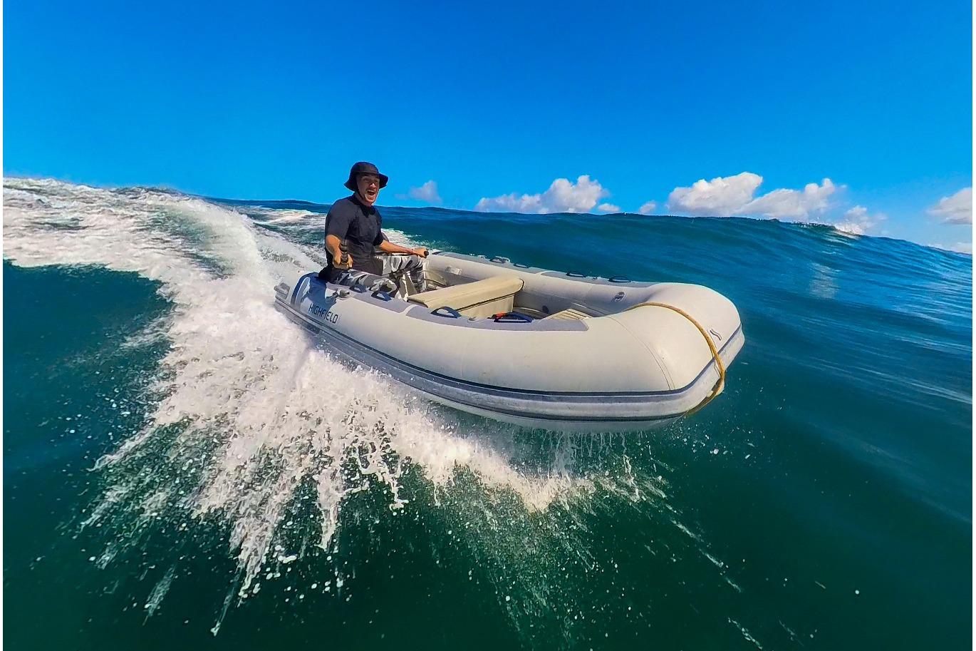 Man riding 2026 Highfield Classic 310 inflatable boat on waves.