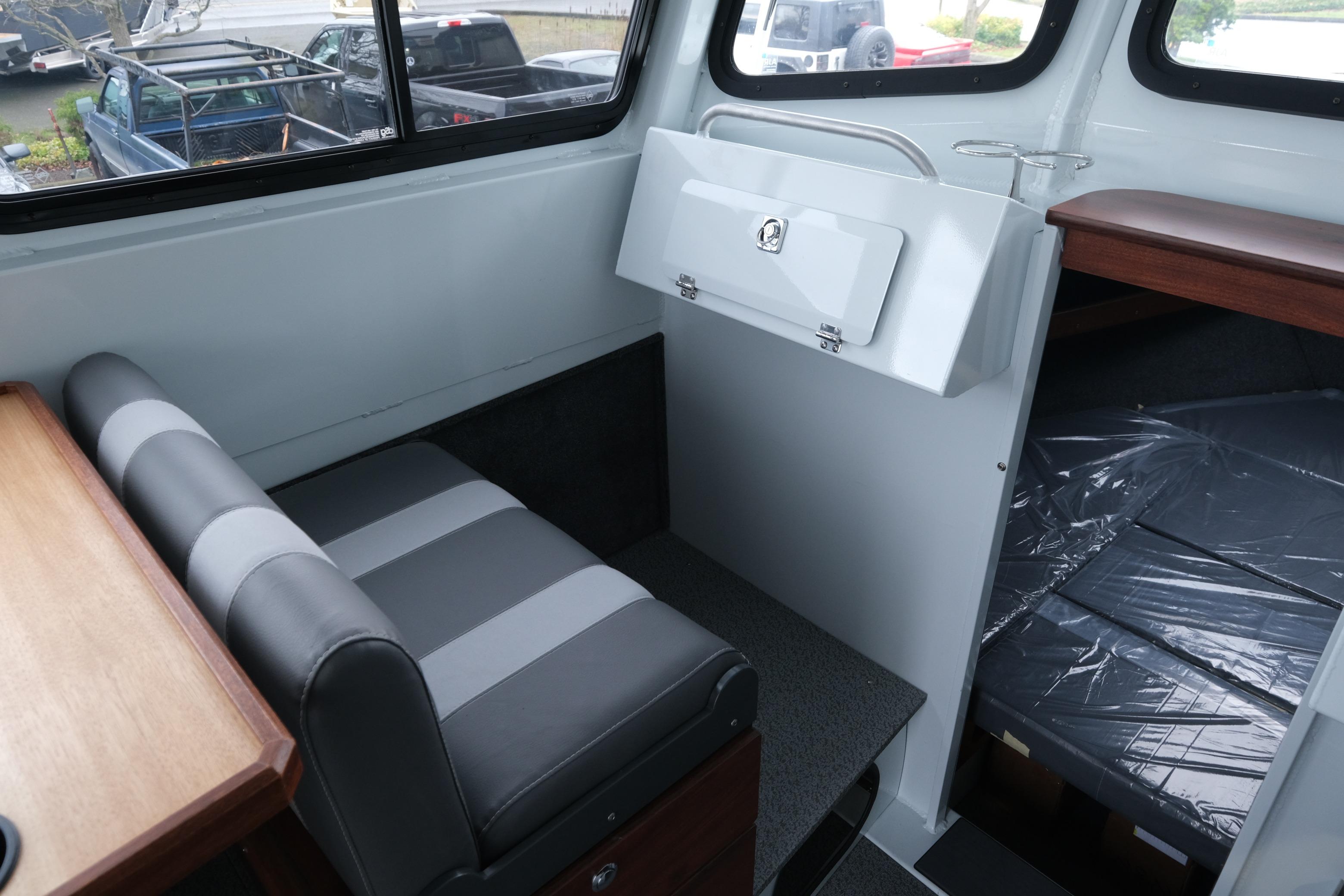 Interior of 2026 Hewescraft 270 Pacific Explorer with seating and storage area.