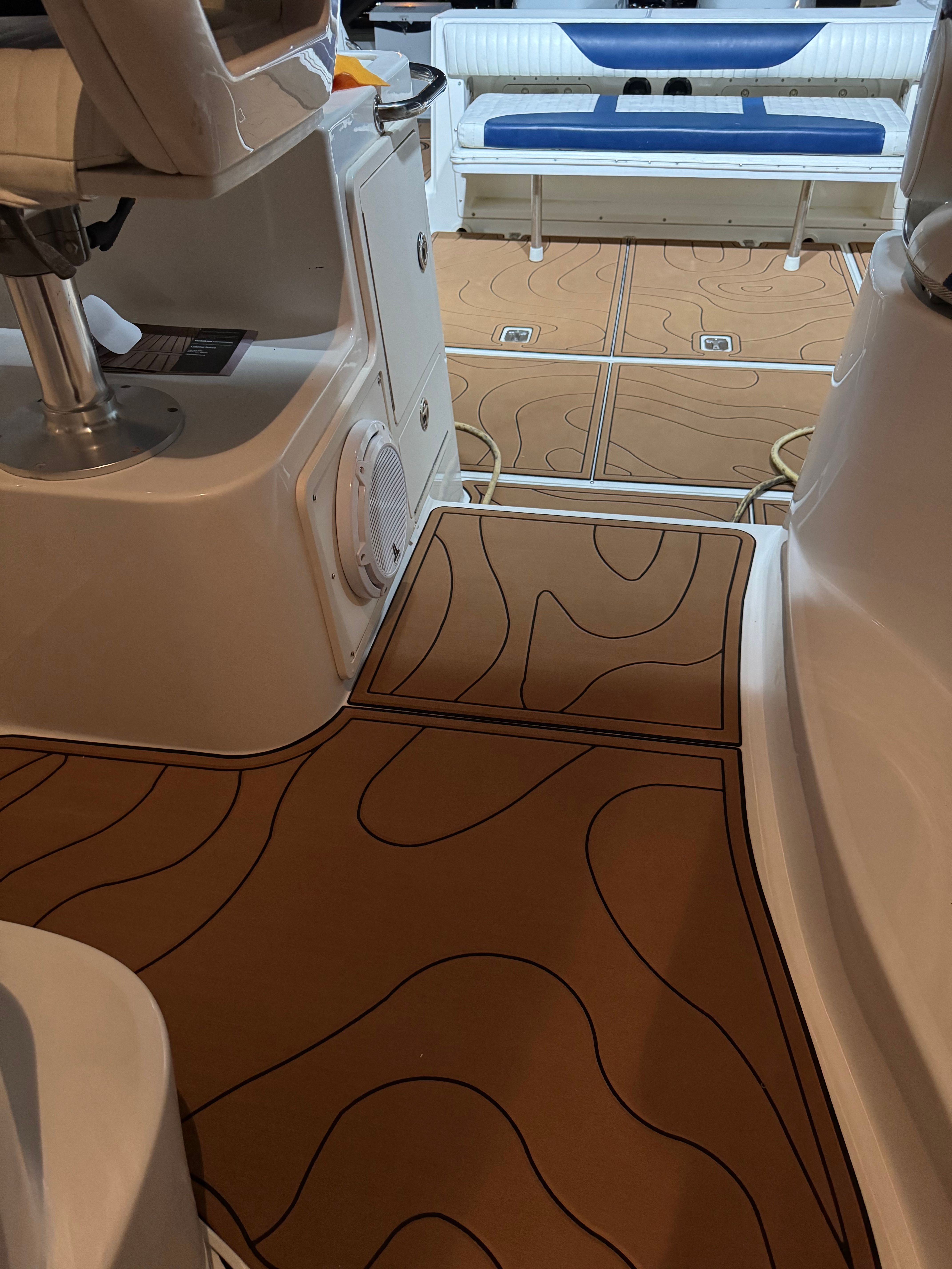 Interior of a 2005 Boston Whaler 305 Conquest boat with wood flooring.