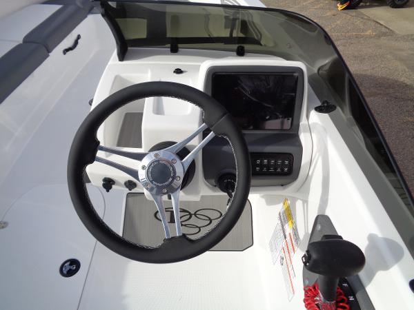 2024 Tahoe T21 boat dashboard with steering wheel and control panel.